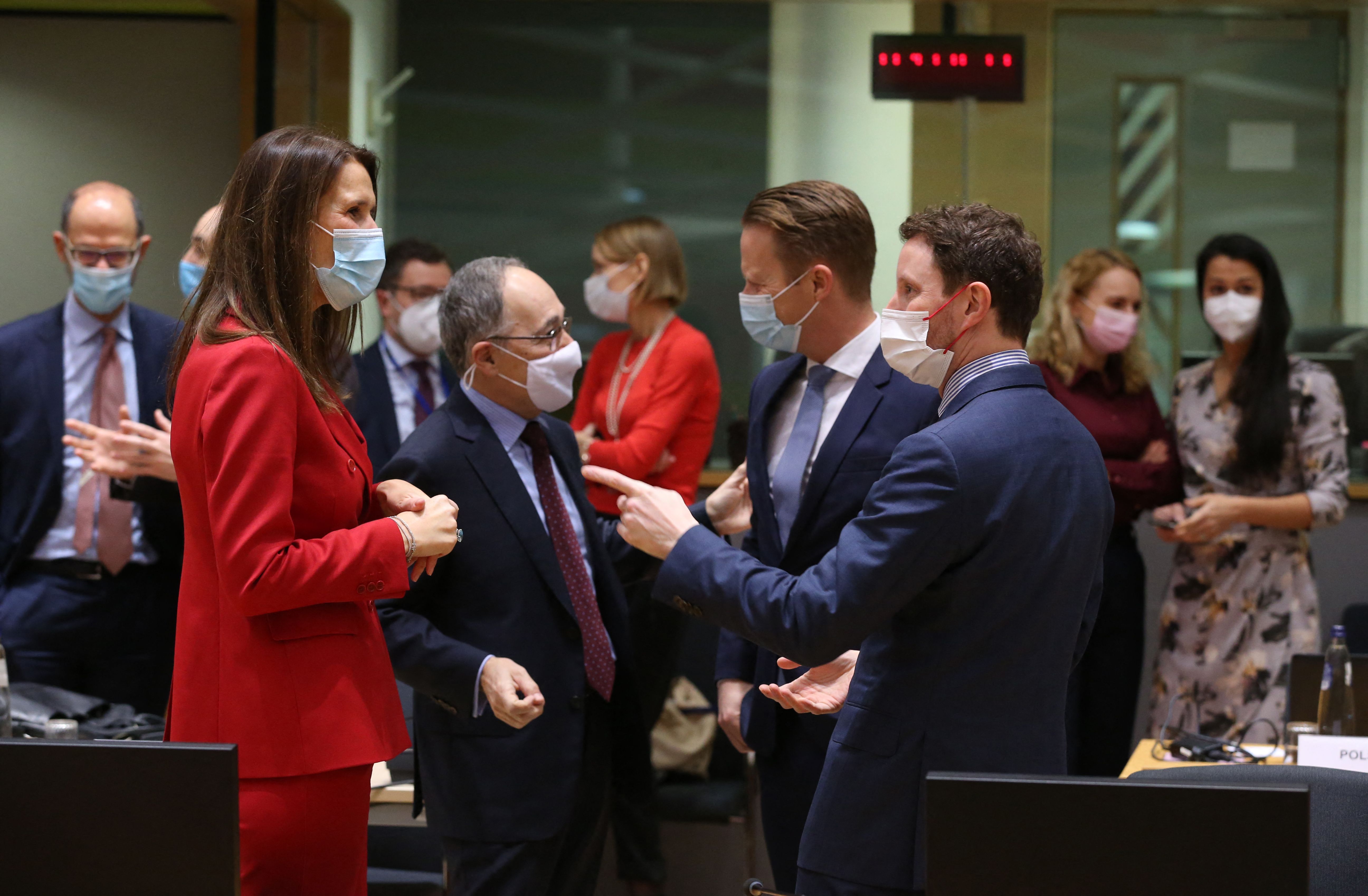 Belgium's Foreign Affairs Minister Sophie Wilmes (L) and Spanish State Secretary for the European Union Pascual Navarro (2L) and French Minister for European Affairs Clement Beaune (R) speak ahead of the start of a General Affairs ministers council (GAC) at EU headquarters in Brussels on January 25, 2022. (Photo by Fran�ois WALSCHAERTS / AFP)