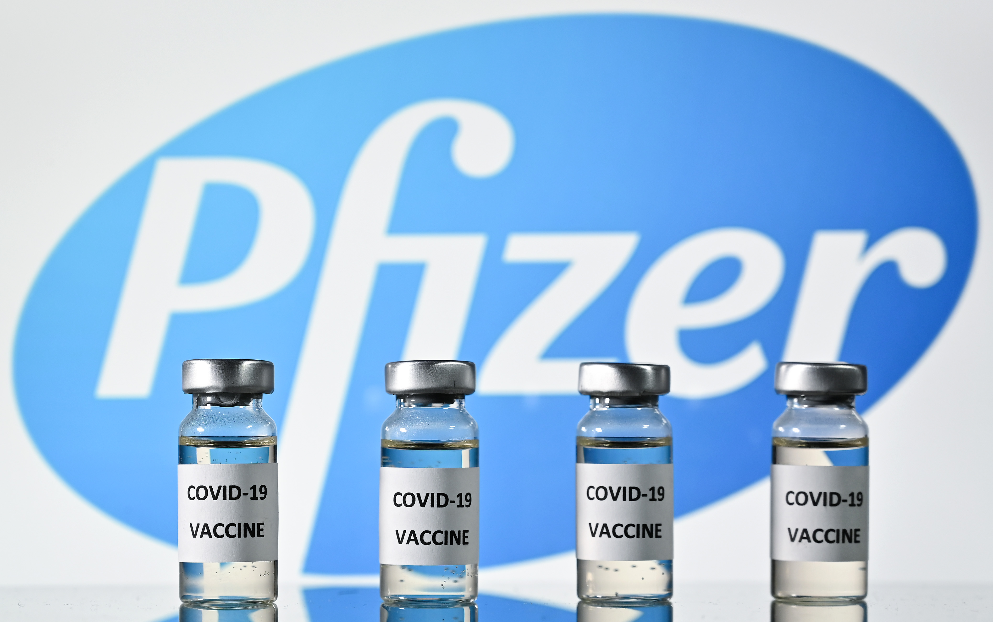 (FILES) This file photo illustration picture shows vials with Covid-19 Vaccine stickers attached, with the logo of US pharmaceutical company Pfizer, on November 17, 2020. - Pfizer and BioNTech said on November 18, 2020 a completed analysis of their experimental Covid-19 vaccine found it protected 95 percent of people against the disease and announced they were applying for US emergency approval "within days." The US pharmaceutical company and its German partner brought further hope to a world upended by the coronavirus pandemic with the announcement, which follows one last week when they said a preliminary analysis showed the product was 90 percent effective. (Photo by JUSTIN TALLIS / AFP)