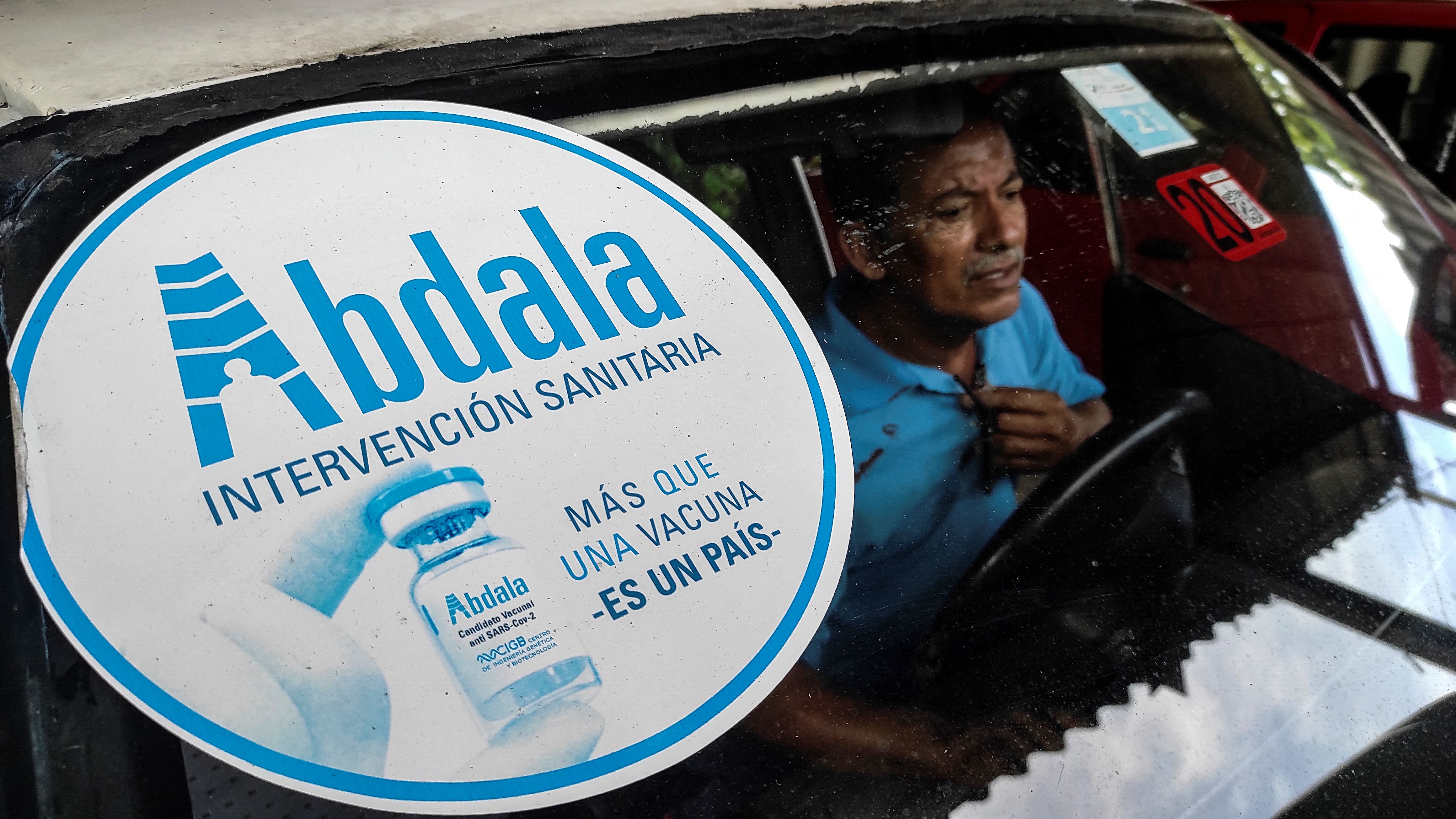 A sticker of the Cuban Abdala vaccine against COVID-19 is seen on the windshield of a car in Havana, on July 9, 2021. - The Center for State Control of Medicines, Equipment and Medical Devices (CECMED) authorized on July 9 the emergency use of the Cuban vaccine Abdala against COVID-19. (Photo by YAMIL LAGE / AFP)