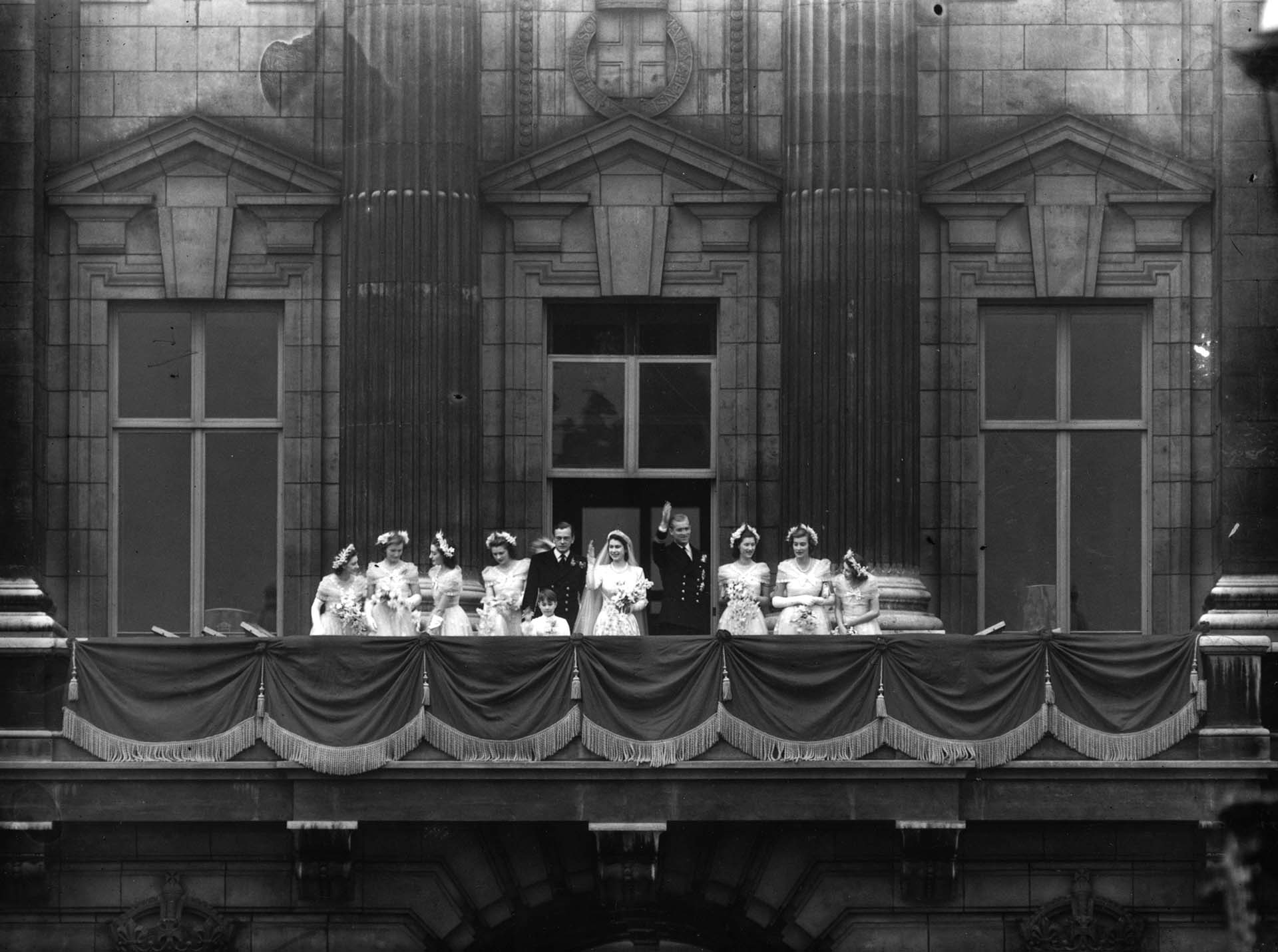 20 de noviembre de 1947:  La princesa Isabel, más tarde reina Isabel II de Gran Bretaña, y el príncipe Felipe, con miembros de la familia real, saludan desde el balcón del Palacio de Buckingham tras su boda.  (Photo by Reg Speller/Fox Photos/Getty Images)