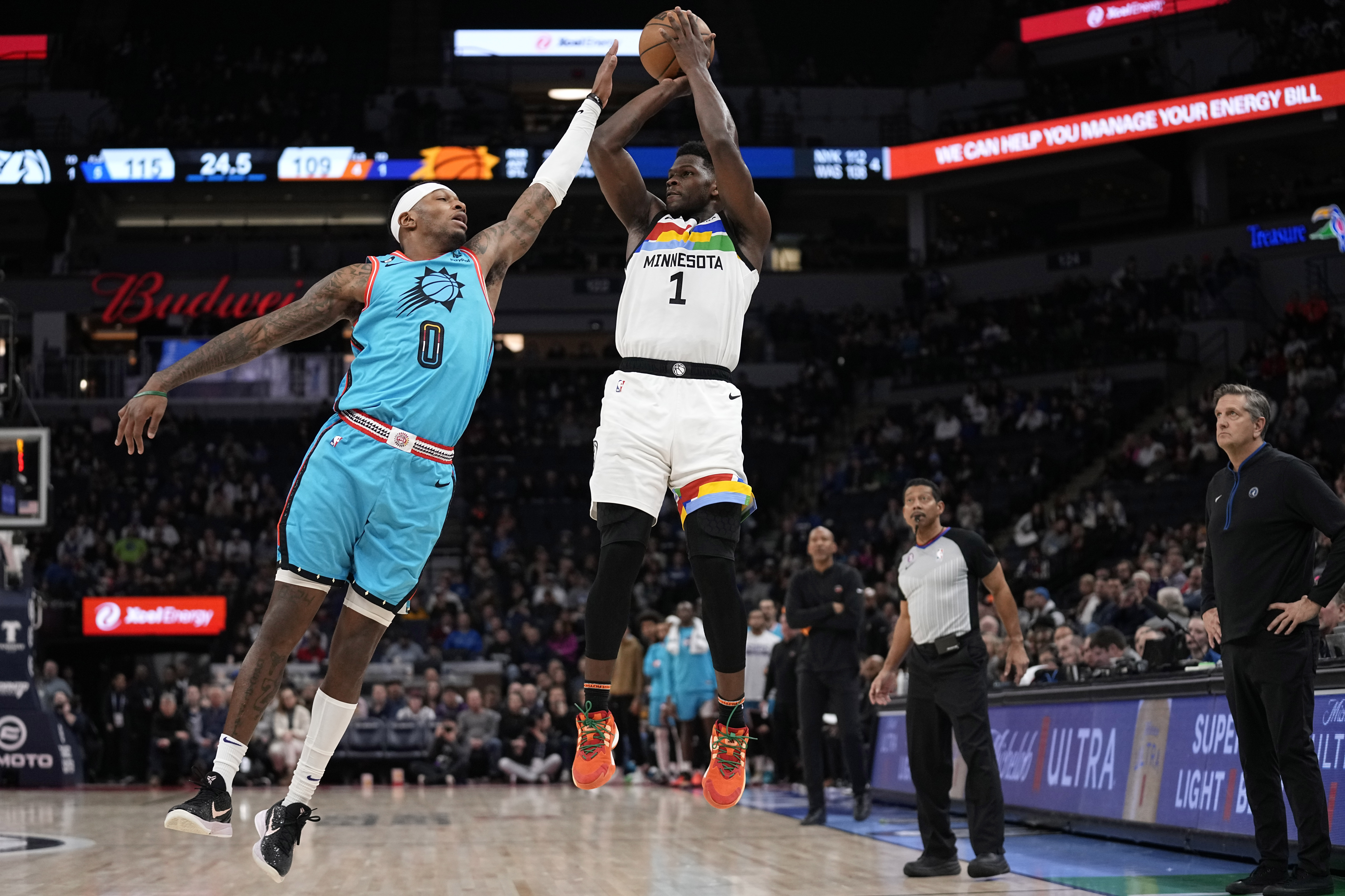Anthony Edwards (1) of the Minnesota Timberwolves throws a shot in front of the mark of Torrey Craig (0) of the Phoenix Suns in the second half of an NBA game in Minneapolis, Friday, January 13, 2023. (AP Photo/Abbie Parr)