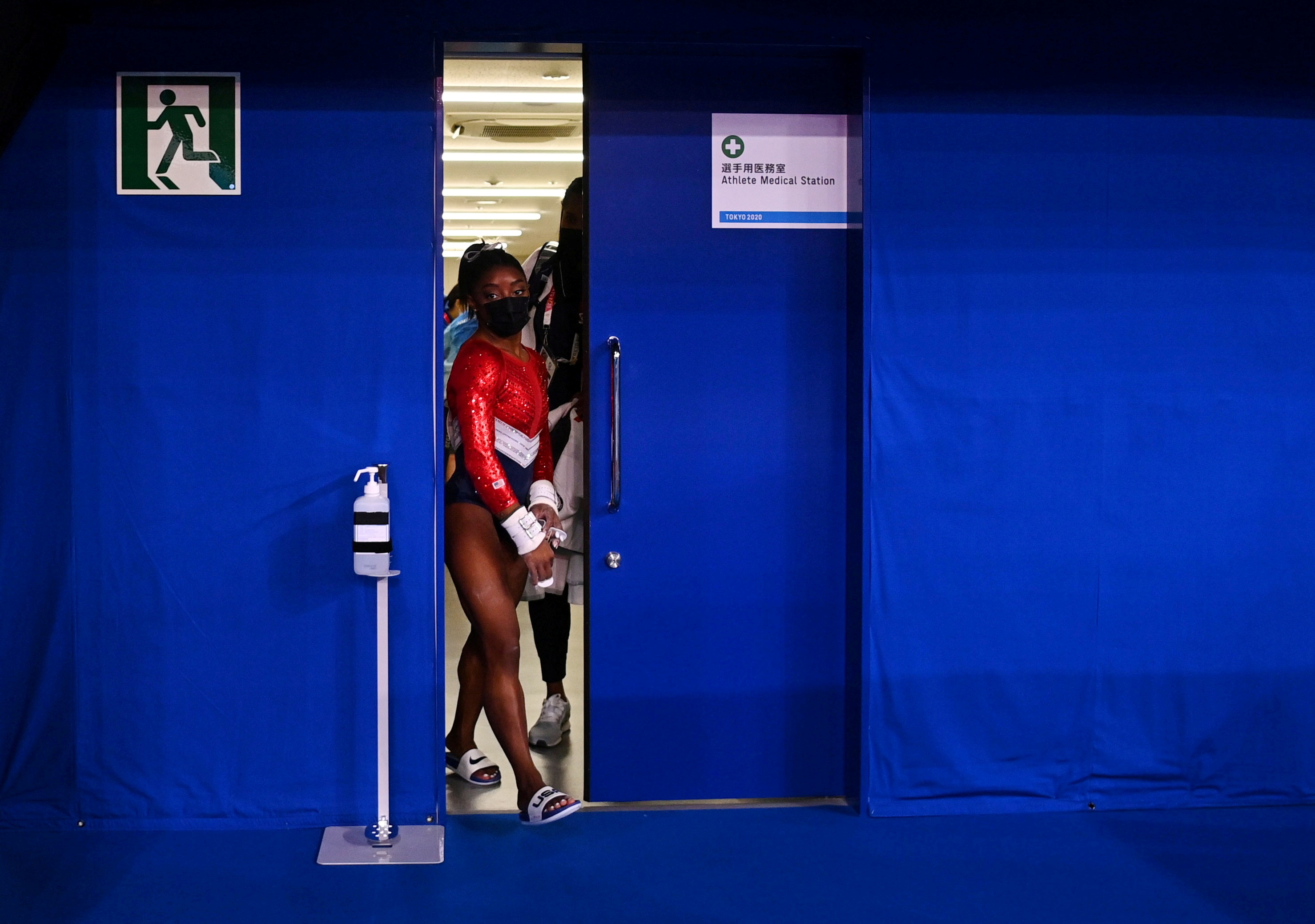 Tokyo 2020 Olympics - Gymnastics - Artistic - Women's Team - Final - Ariake Gymnastics Centre, Tokyo, Japan - July 27, 2021. Simone Biles of the United States wearing a protective face mask is seen leaving a medical station during the final REUTERS/Dylan Martinez/File Photo     TPX IMAGES OF THE DAY SEARCH "POY SPORTS" FOR THIS STORY. SEARCH "REUTERS POY" FOR ALL BEST OF 2021 PACKAGES