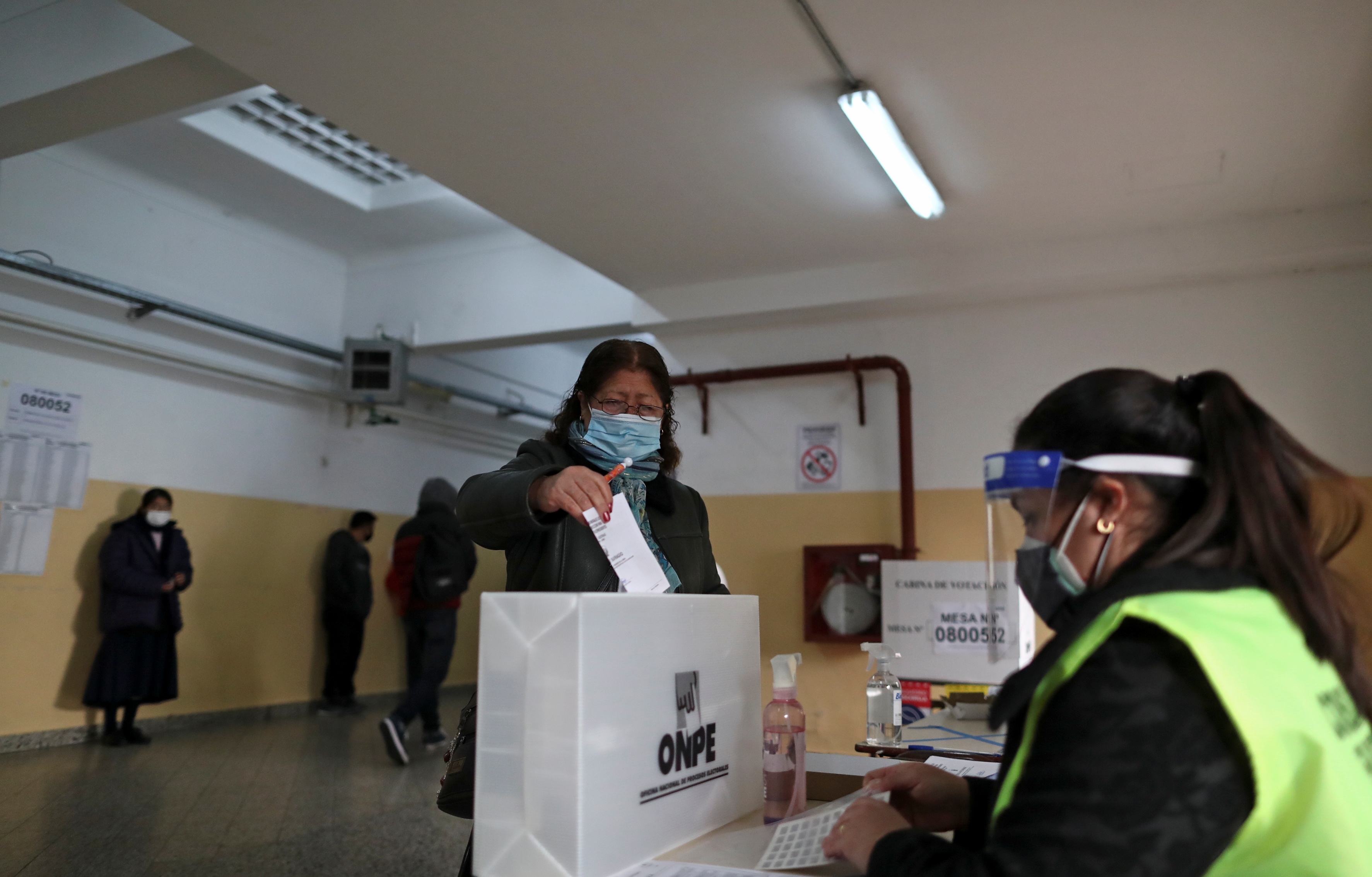 A Peruvian woman residing in Argentina casts her vote at a polling station in a public school, during her country's run-off elections between front runner socialist candidate Pedro Castillo and his right-wing opponent Keiko Fujimori, in Buenos Aires, Argentina June 6, 2021. REUTERS/Agustin Marcarian