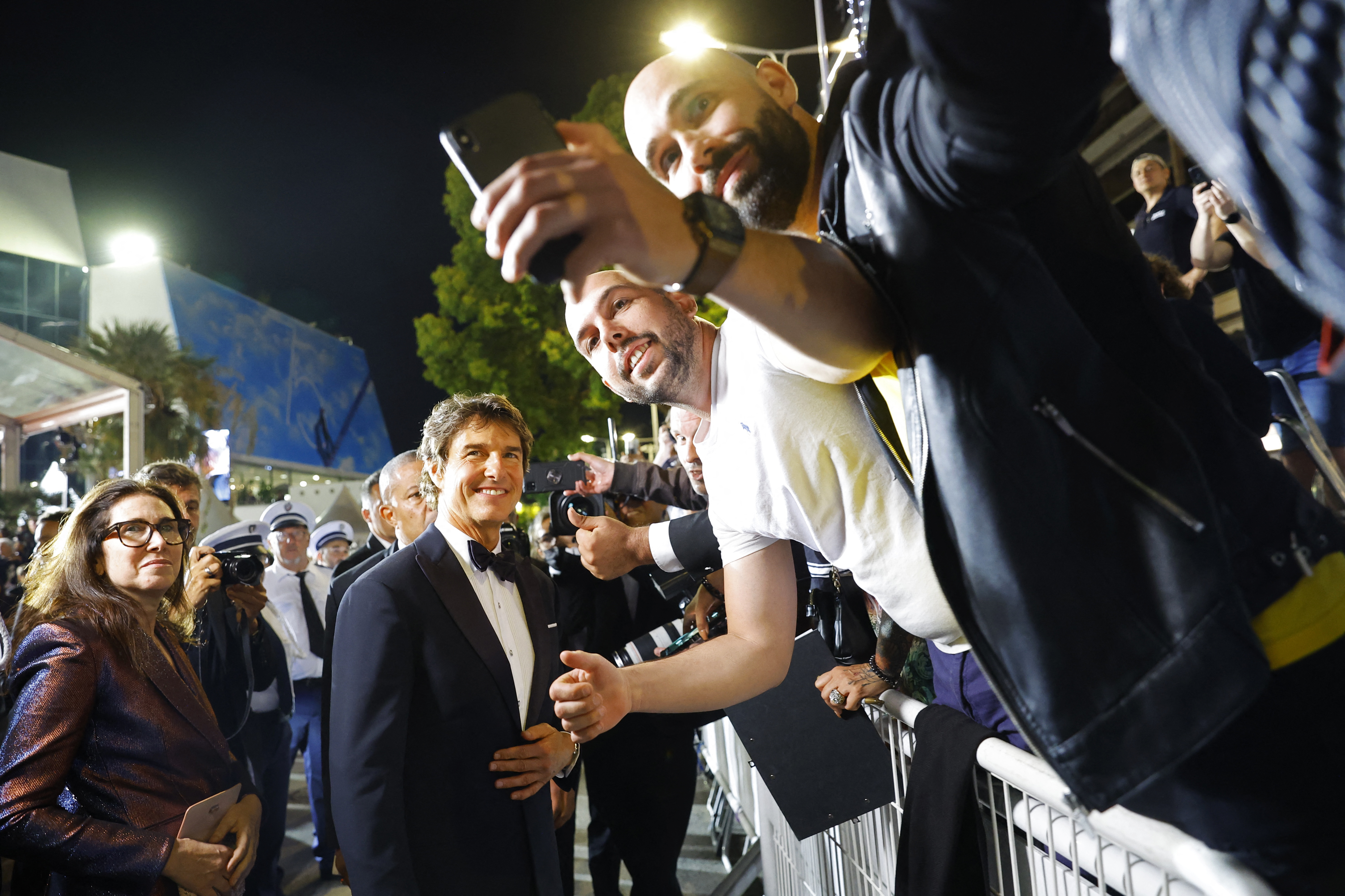 Tom Cruise, a little human God, poses with his fans in Cannes.  REUTERS/Stephane Mahe