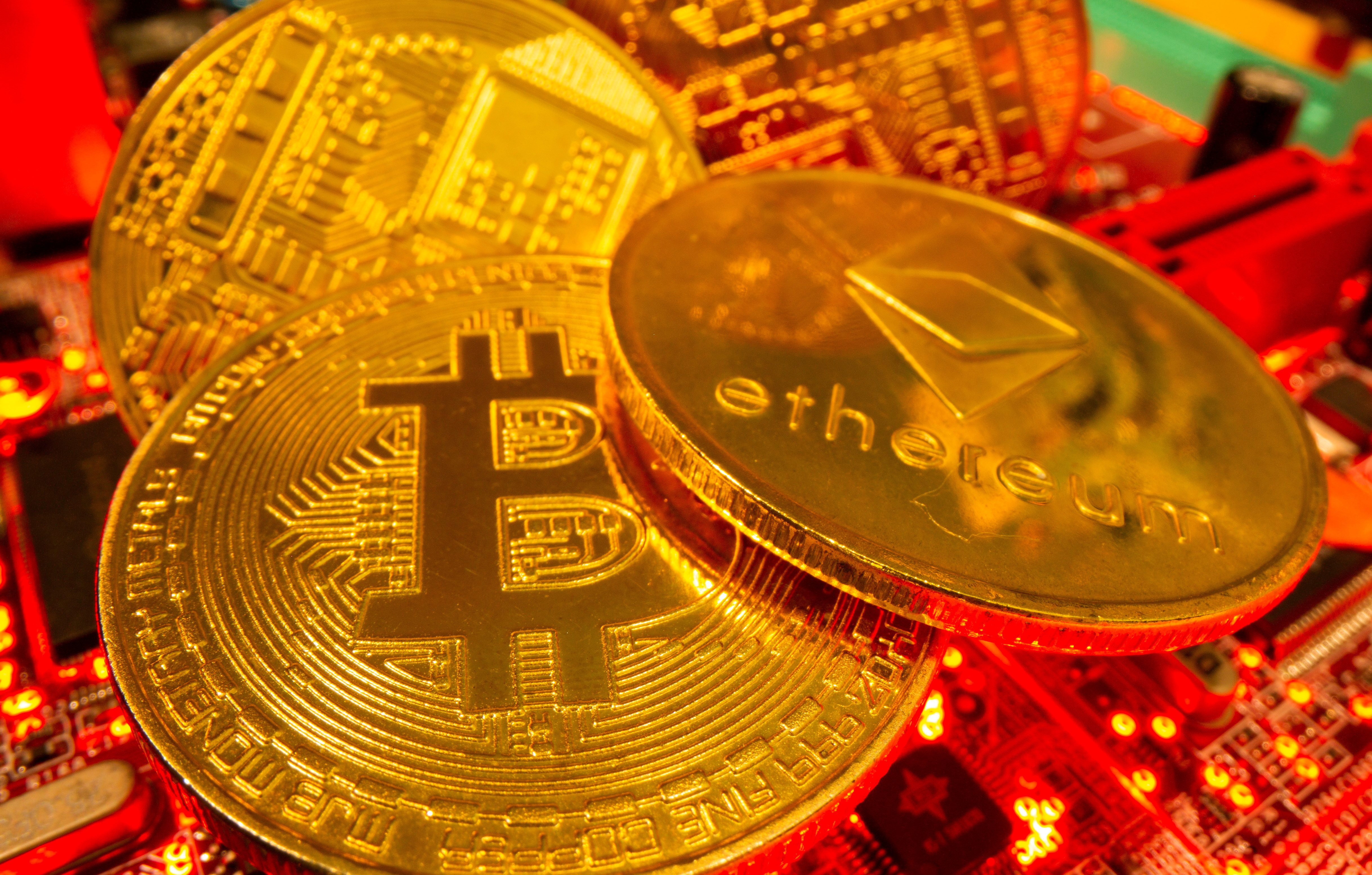 FILE PHOTO: Representations of the virtual currency Bitcoin and Ethereum stand on a motherboard in this picture illustration taken May 20, 2021. REUTERS/Dado Ruvic/Illustration/File Photo/File Photo