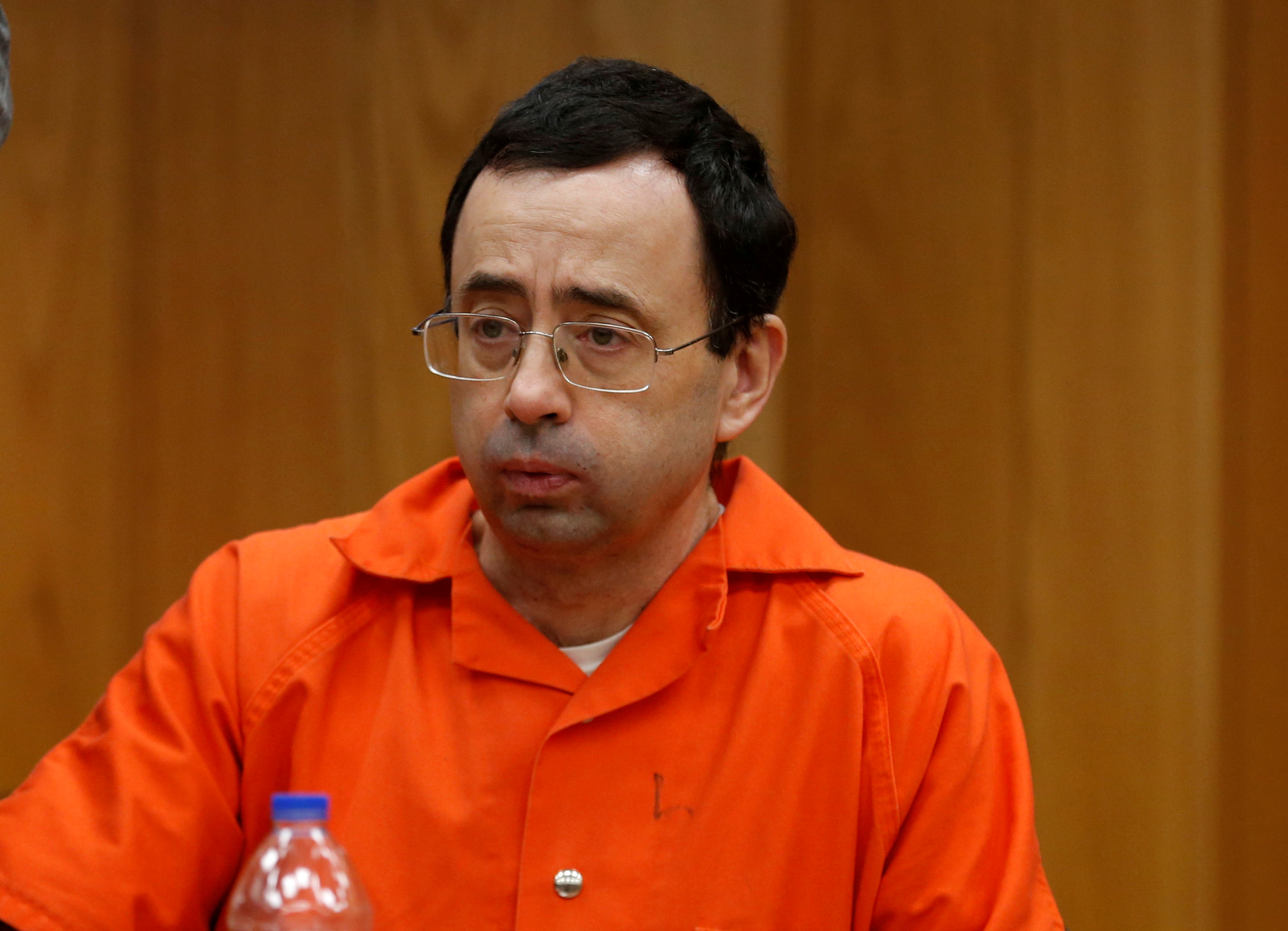 FILE PHOTO: Larry Nassar, a former team USA Gymnastics doctor who pleaded guilty in November 2017 to sexual assault charges, sits in the courtroom during his sentencing hearing in the Eaton County Court in Charlotte, Michigan, U.S., February 2, 2018.   REUTERS/Rebecca Cook/File Photo