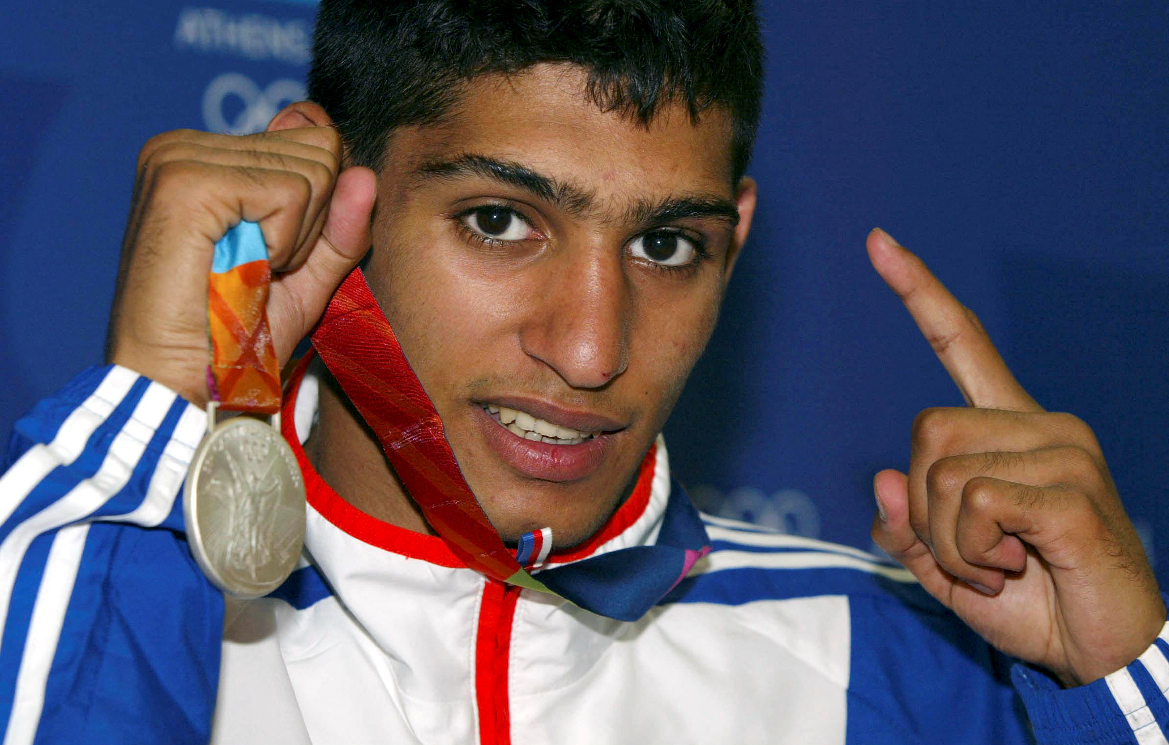 FILE PHOTO: Boxing - Olympics - Athens 2004 Olympic Games - Athens - 29/8/04  Amir Khan with the Olympic Silver Medal he won for Britain today  Action Images via Reuters/Richard Heathcote/File Photo