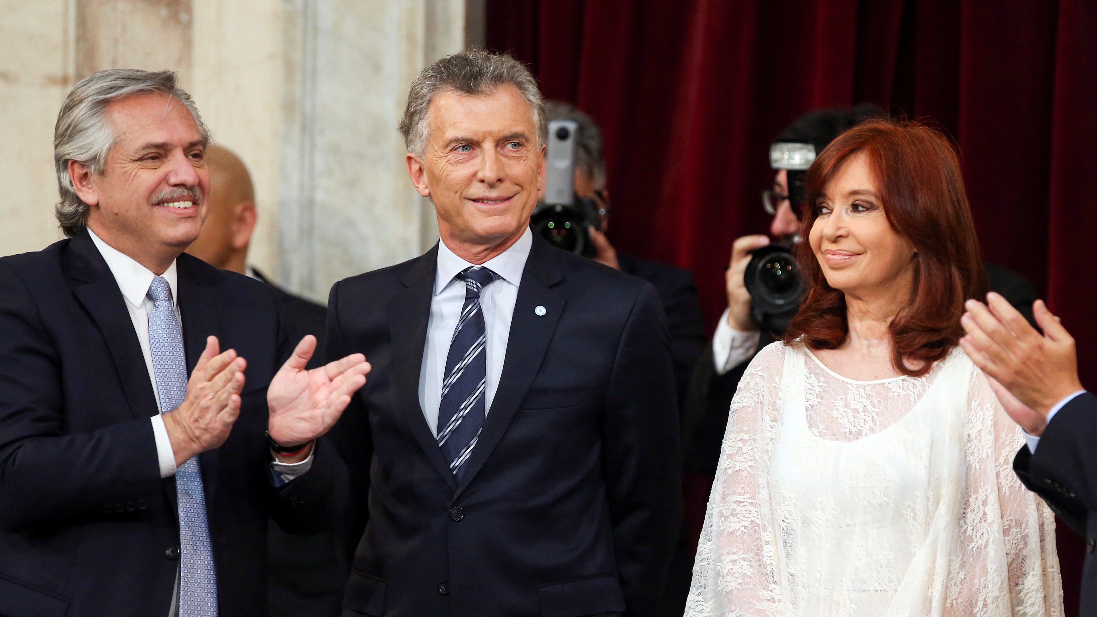 Argentina's President Alberto Fernandez gestures next to Vice President Cristina Fernandez de Kirchner and former Argentina's President Mauricio Macri after he was sworn in, in Buenos Aires, Argentina December 10, 2019. REUTERS/Agustin Marcarian