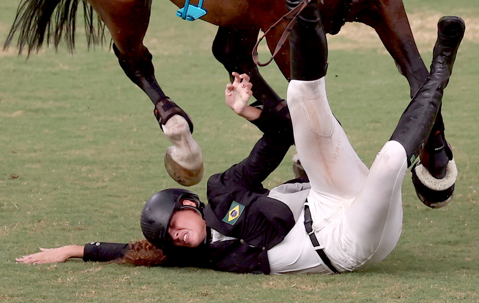 Tokyo 2020 Olympics - Modern Pentathlon - Women's Riding - Tokyo Stadium - Tokyo, Japan - August 6, 2021. Ieda Guimaraes of Brazil falls from her horse during the competition REUTERS/Ivan Alvarado/File Photo     TPX IMAGES OF THE DAY SEARCH "POY SPORTS" FOR THIS STORY. SEARCH "REUTERS POY" FOR ALL BEST OF 2021 PACKAGES