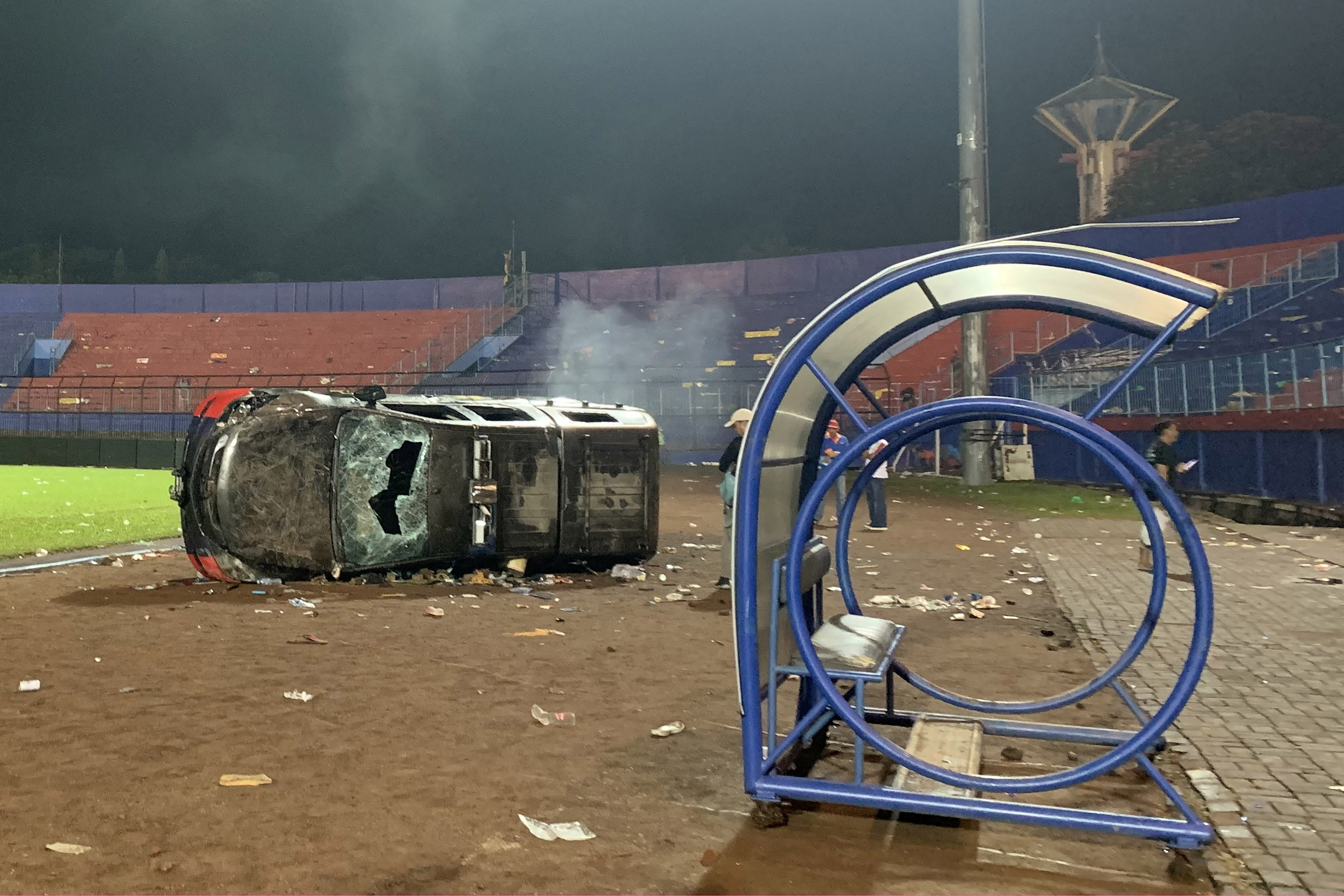 Un automóvil policial dañado durante un motín después del partido de fútbol de la liga BRI Liga 1 entre Arema y Persebaya (Reuters)