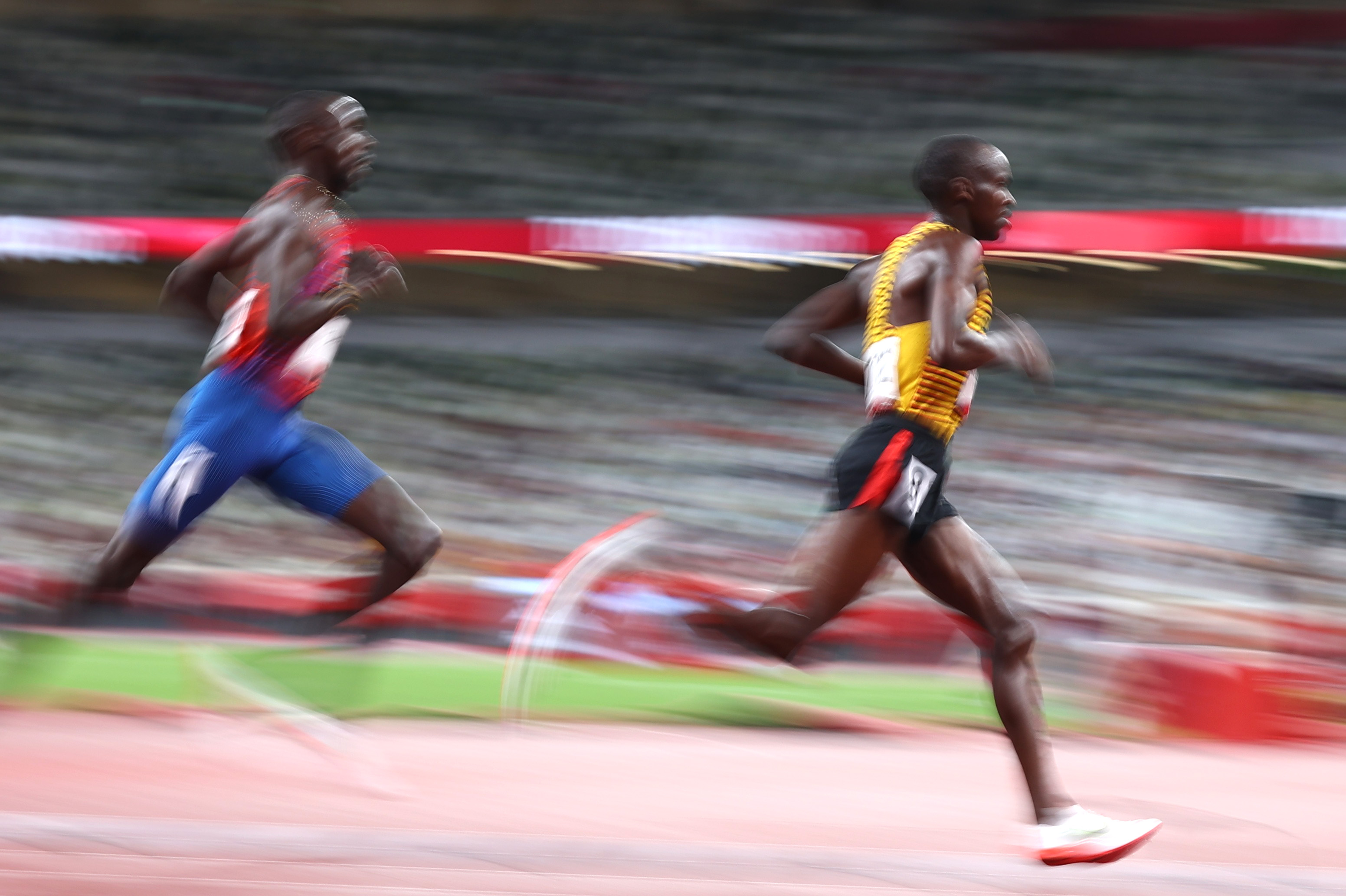 Tokyo 2020 Olympics - Athletics - Men's 5000m - Final - Olympic Stadium, Tokyo, Japan - August 6, 2021. Jacob Kiplimo of Uganda in action with Paul Chelimo of the United States REUTERS/Lucy Nicholson