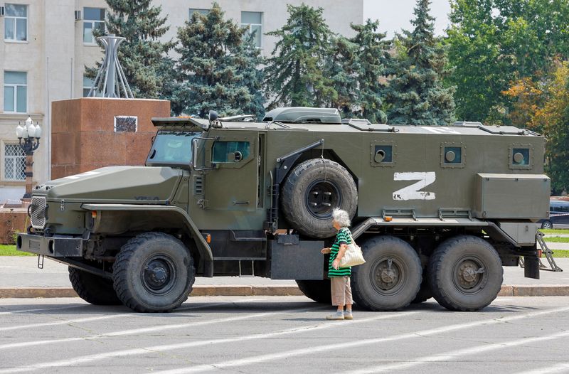 An armored truck of pro-Russian troops stands near the building of the former Ukrainian Regional Council during Ukraine-Russia clashes in the Russian-controlled city of Kherson, Ukraine.  July 25, 2022. REUTERS/Alexander Ermochenko/File