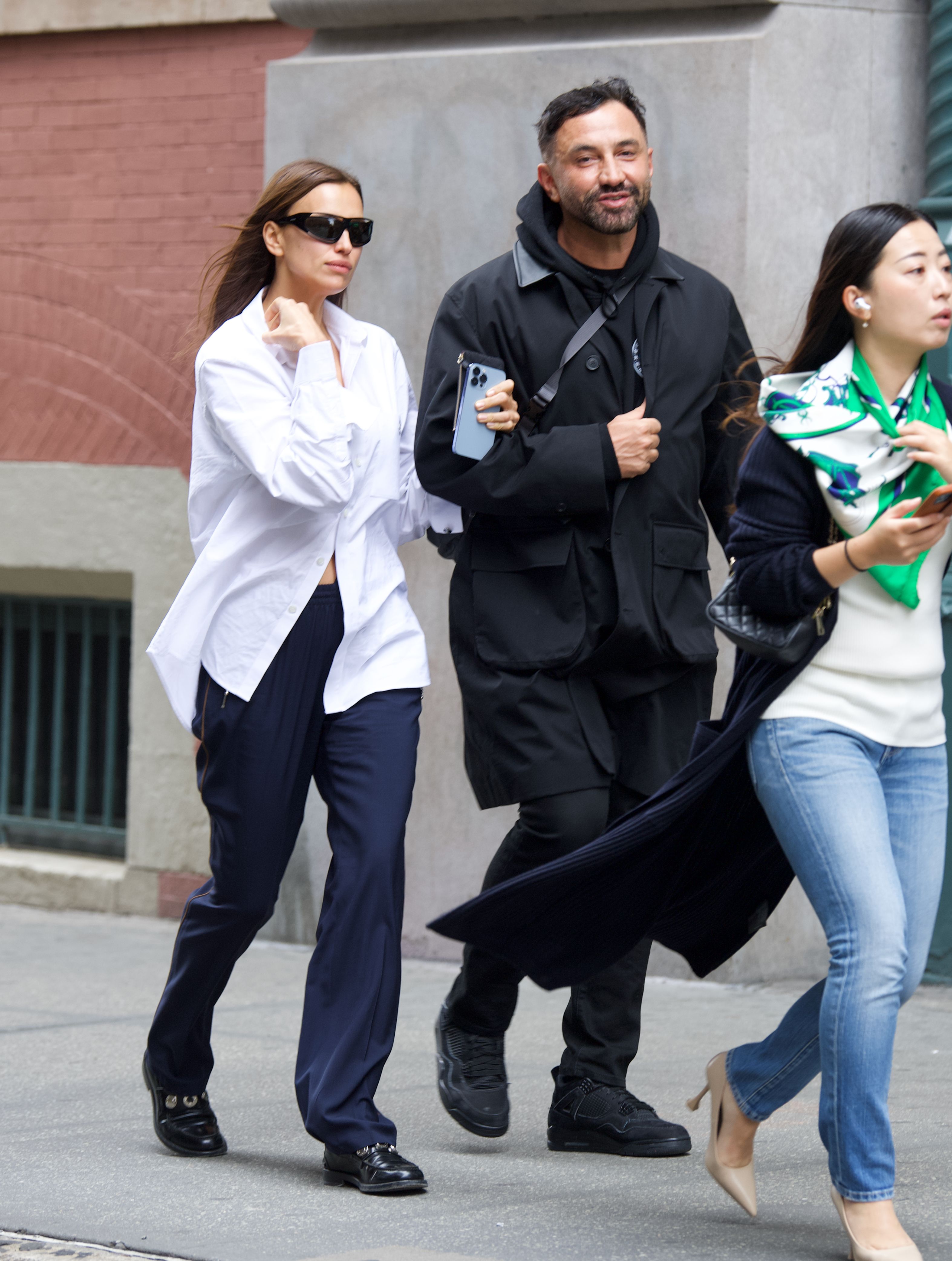 Día de compras. Irina Shayk fue fotografiada mientras caminaba del brazo de Riccardo Tisci por las calles de barrio Soho, en Nueva York. La modelo lució un pantalón azul y una camisa blanca oversize que usó con algunos botones abiertos. Además, llevó lentes de sol