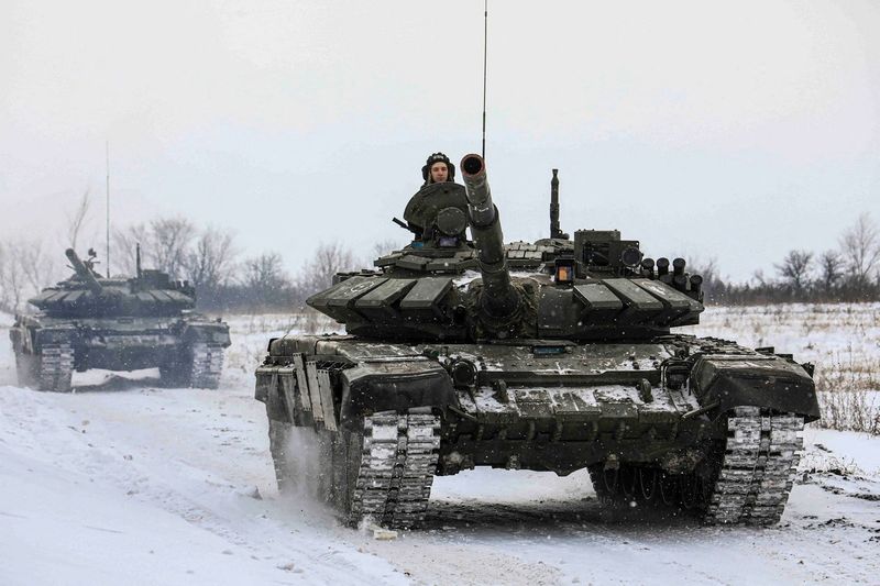 File photo: Russian soldiers riding in a tank during a maneuver in Leningrad Oblast, Russia This homage picture was released on February 14, 2022.  Through the Russian Ministry of Defense / Courtesy REUTERS