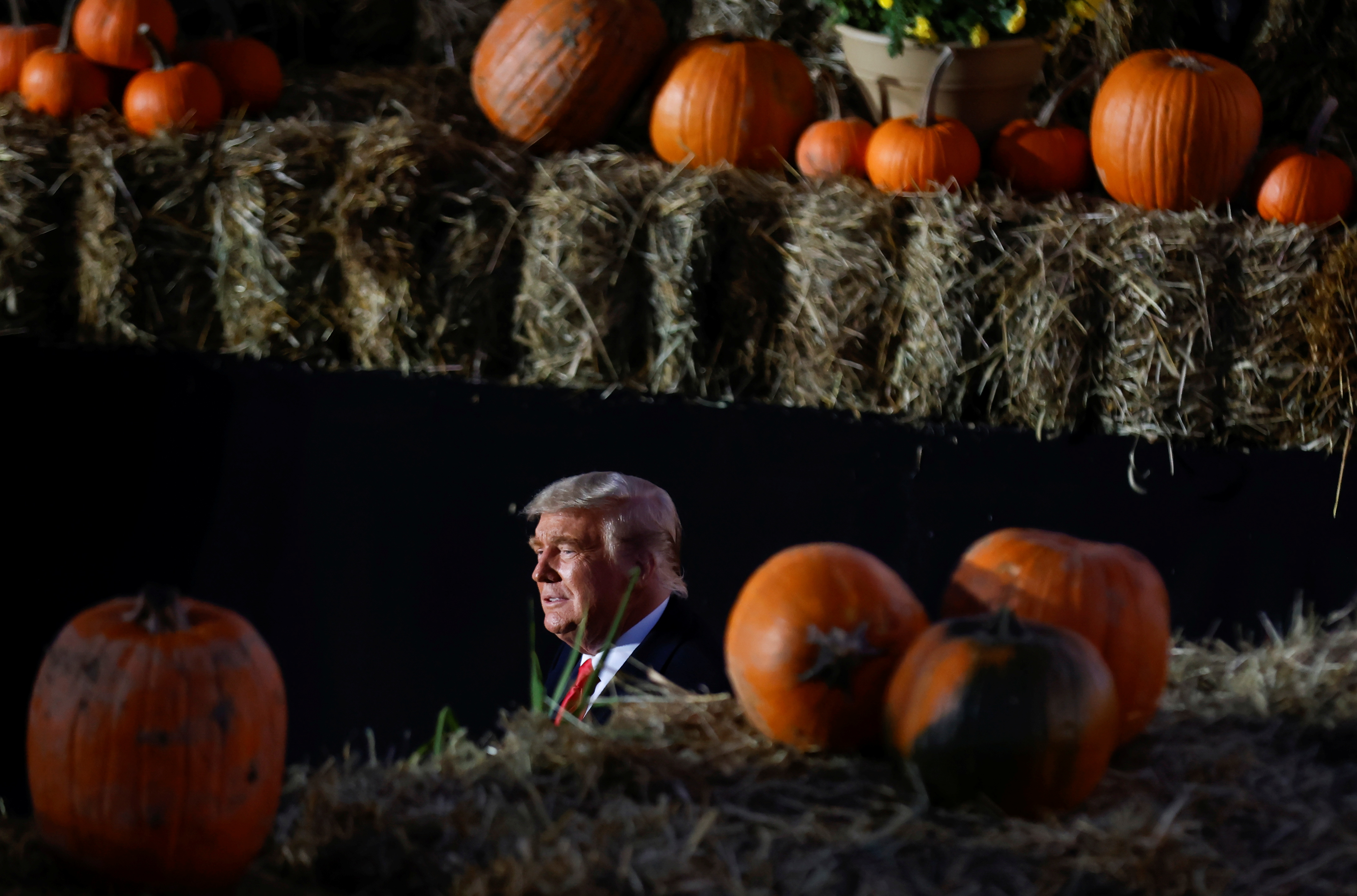 U.S. President Donald Trump is seen between pumpkins during a campaign rally at Pittsburgh-Butler Regional Airport in Butler, Pennsylvania , U.S., October 31, 2020. REUTERS/Carlos Barria