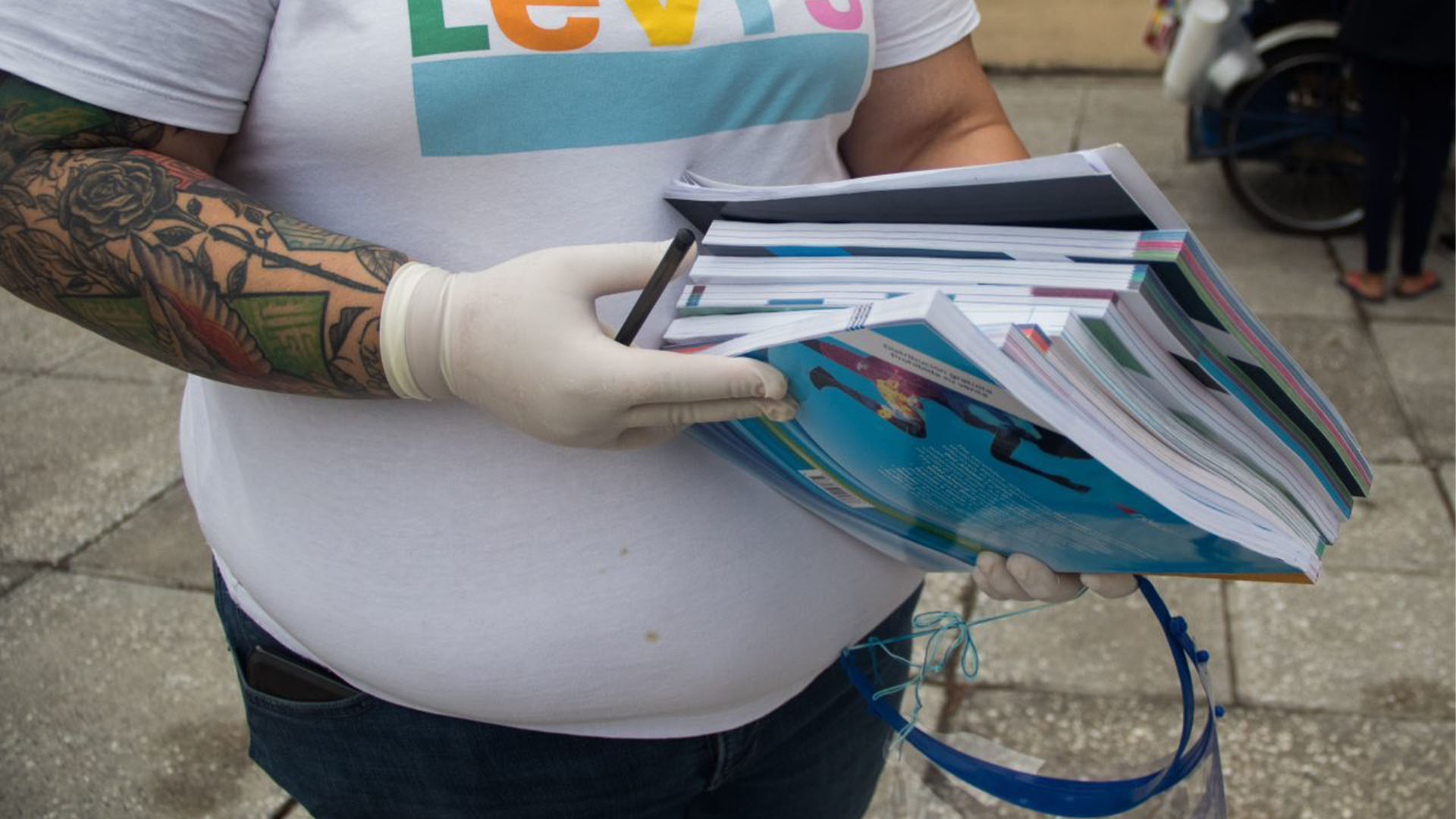Una madre de familia muestra los libros que le fueron entregados para comenzar el ciclo escolar (Foto: Cuartoscuro)