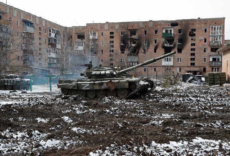 FILE PHOTO: A tank with the letter "z" Graffiti is seen in front of a residential building that was damaged during the Ukraine-Russia conflict in the separatist-controlled town of Volnovaja in Donetsk region, Ukraine.  March 11, 2022. REUTERS/Alexander Ermochenko/File