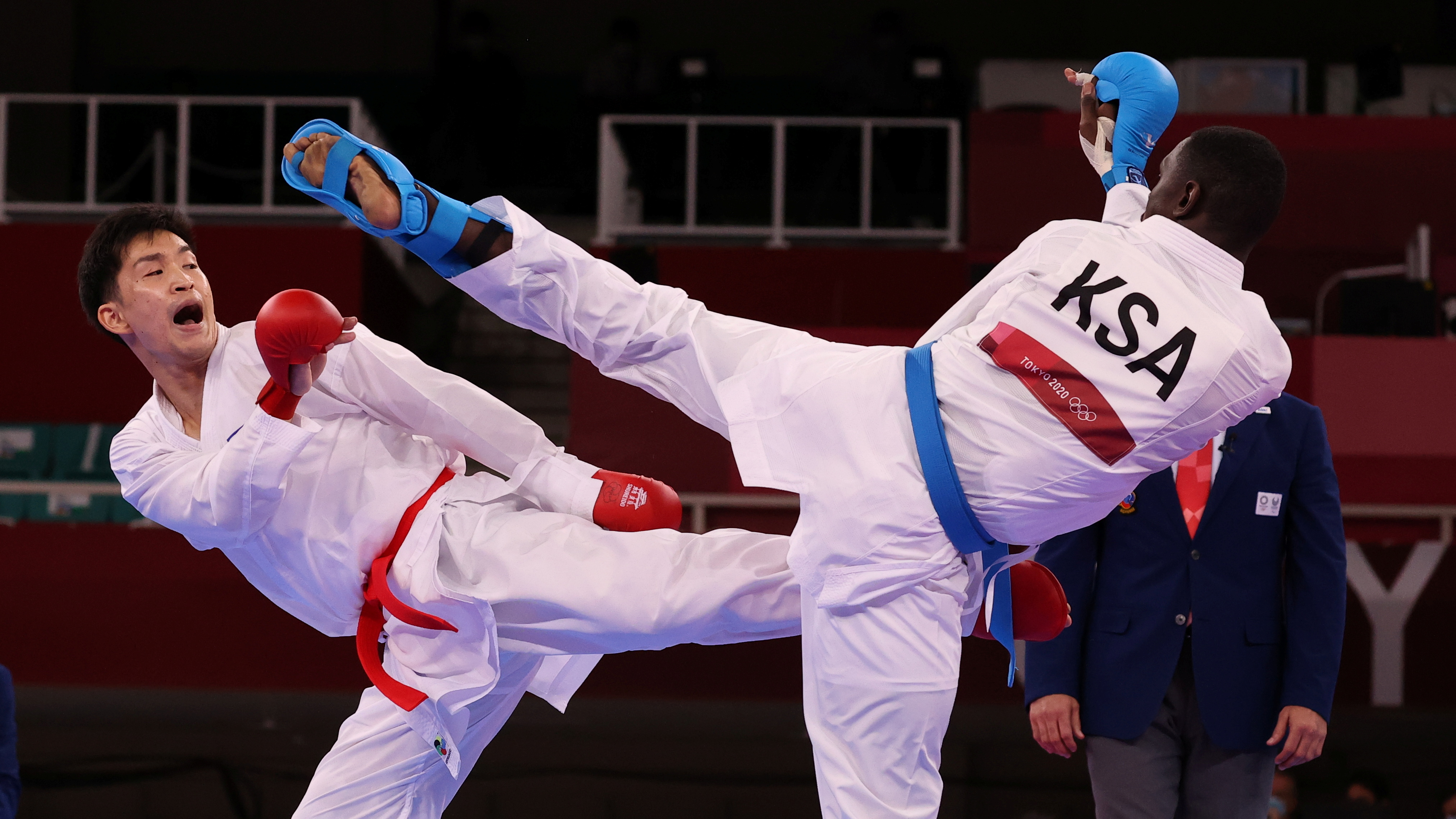 Tokyo 2020 Olympics - Karate - Men's +75kg Kumite - Semifinal - Nippon Budokan, Tokyo, Japan - August 7, 2021. Tareg Hamedi of Saudi Arabia in action against Ryutaro Araga of Japan. REUTERS/Ivan Alvarado