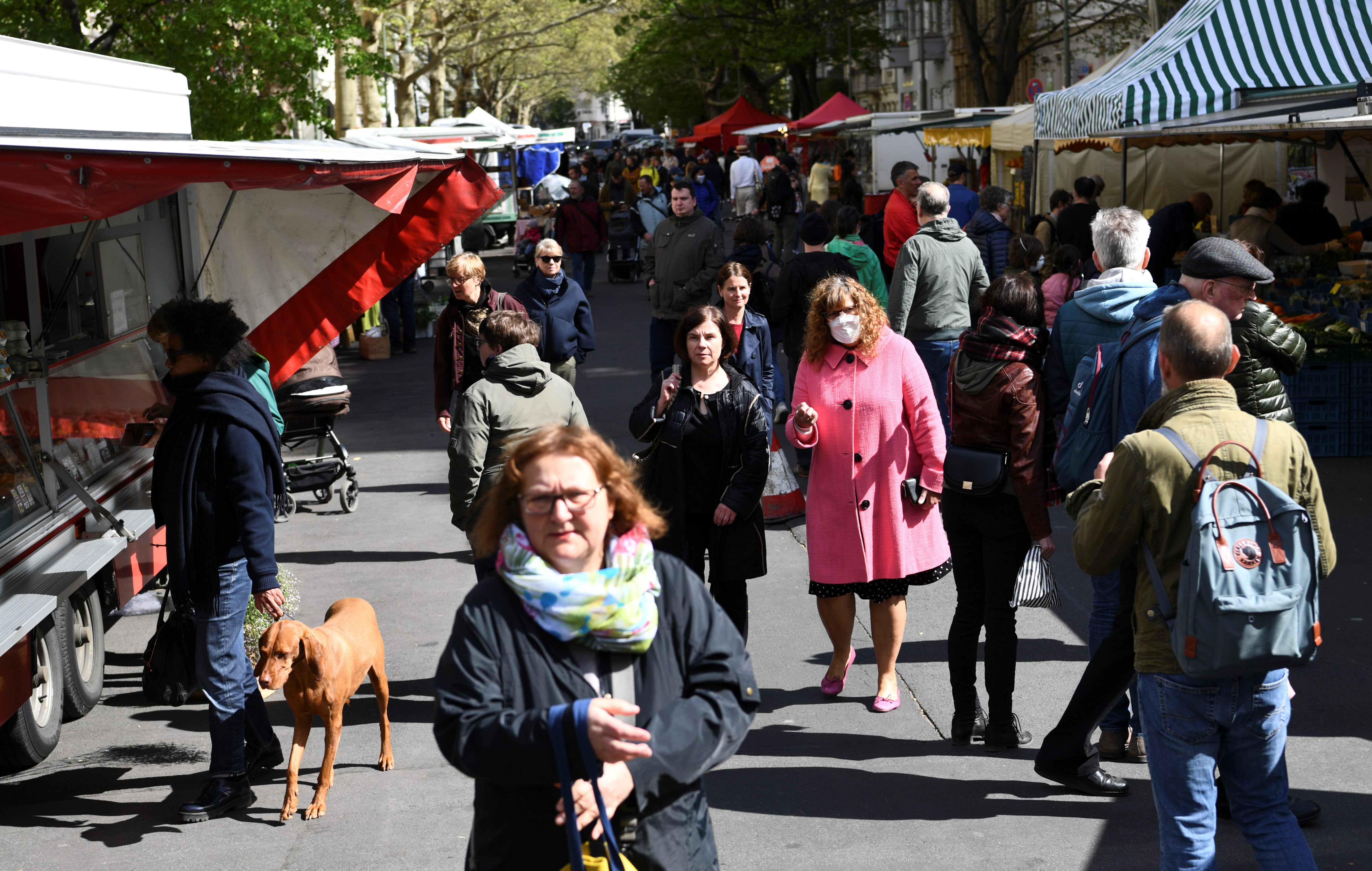 La gente pasa por los puestos de los comerciantes en un mercado semanal en Berlín, Alemania, el 25 de abril de 2020.  (REUTERS/Annegret Hilse)