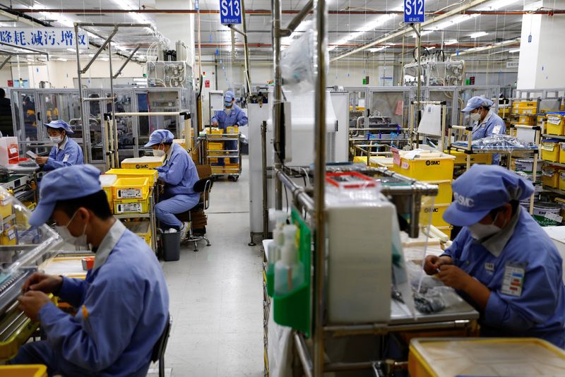 FOTO DE ARCHIVO. Empleados trabajan en una fábrica de SMC Corporation, durante una visita organizada para los medios de comunicación, en medio del brote de la enfermedad por coronavirus (COVID-19) en Pekín, China. 10 de enero de 2023. REUTERS/Tingshu Wang