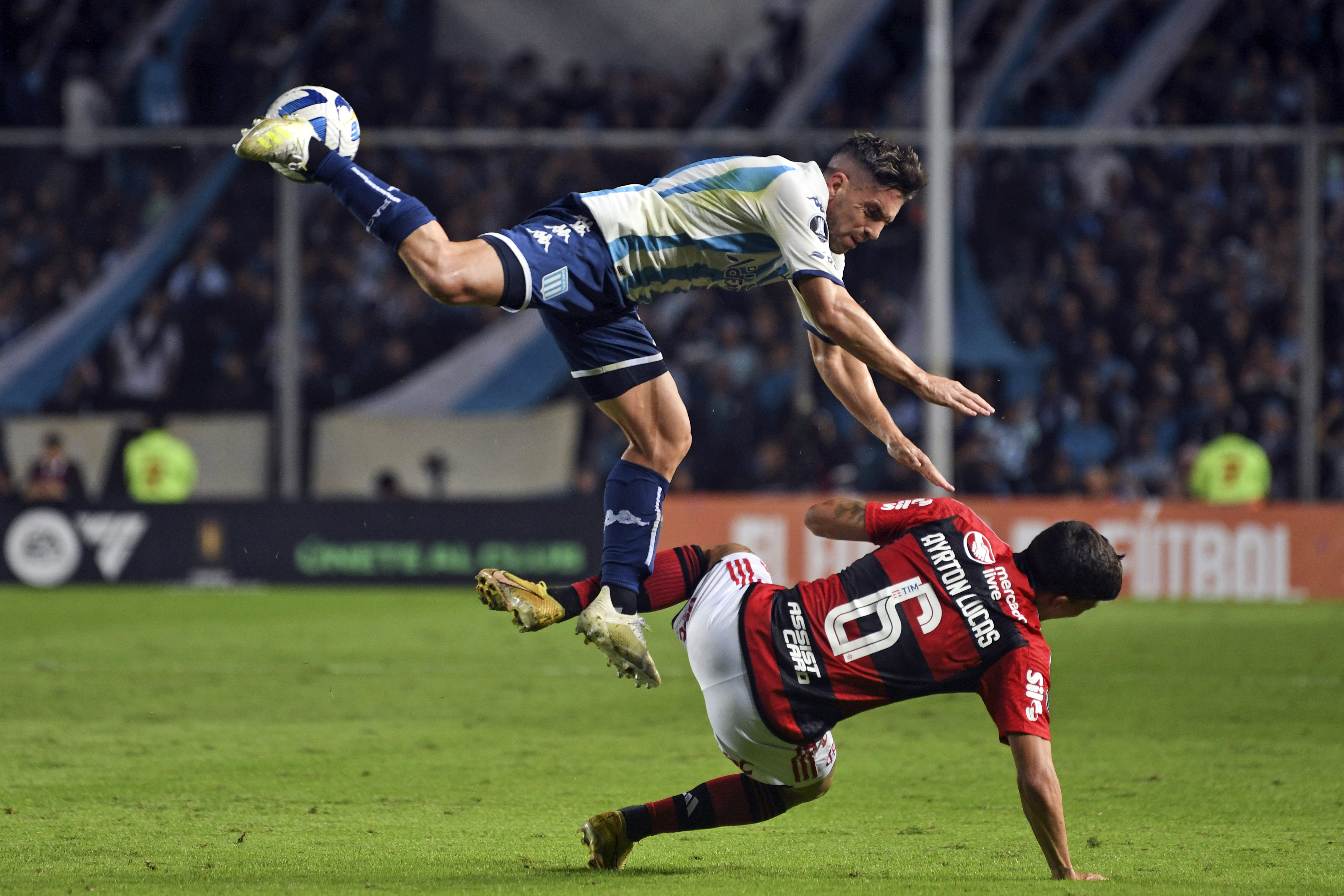 Ayrton Lucas (right) of Brazil's Flamengo is fouled by Gabriel Hauche of Racing Club de Argentina during a Copa Libertadores Group A match at the Presidente Perón stadium in Avellaneda, Argentina on May 4, 2023 (AP Photo/Gustavo Garello)