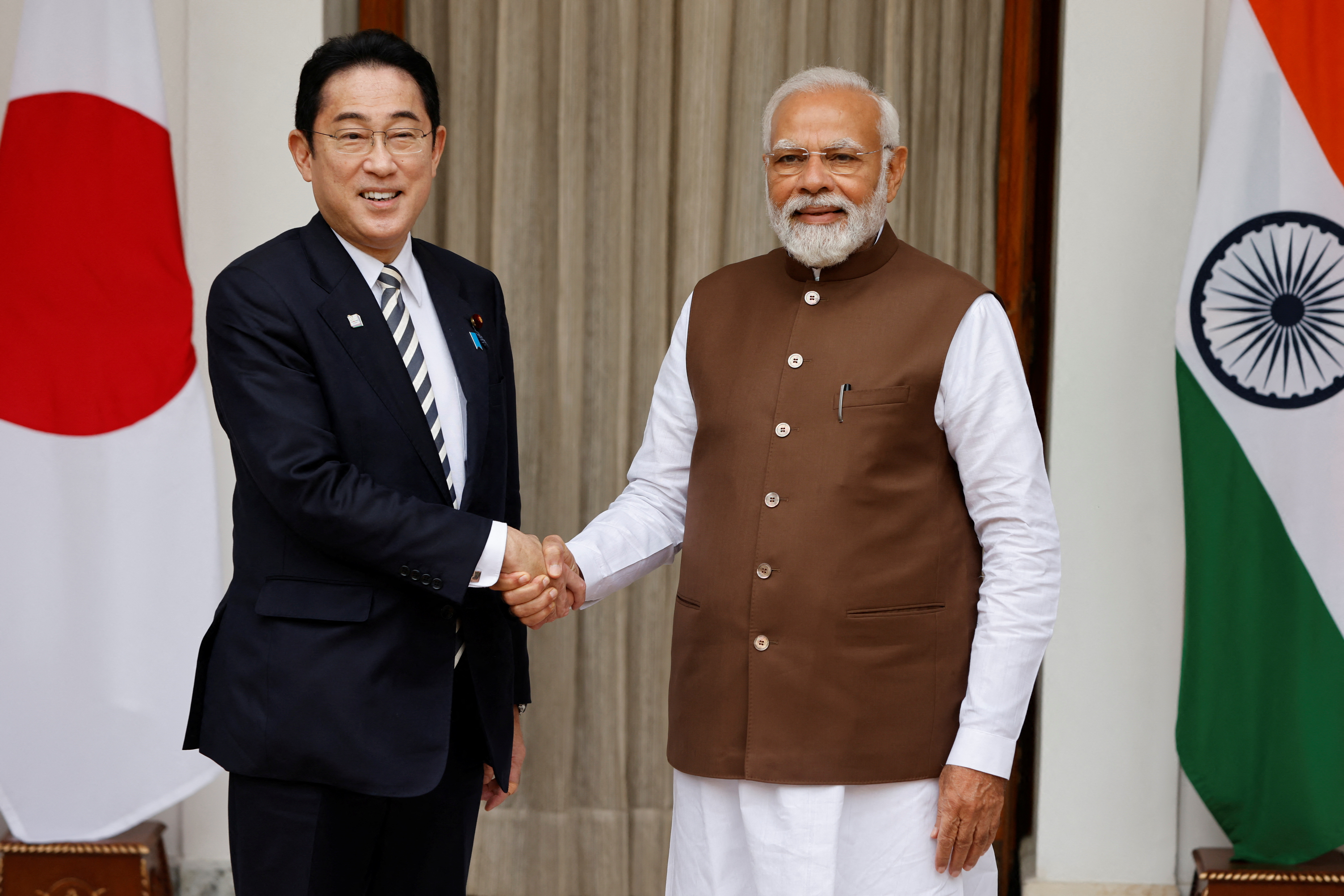 El primer ministro japonés, Fumio Kishida, estrecha la mano de su homólogo indio, Narendra Modi, antes de su reunión en la Hyderabad House de Nueva Delhi, India, 20 de marzo de 2023. (REUTERS/Adnan Abidi)