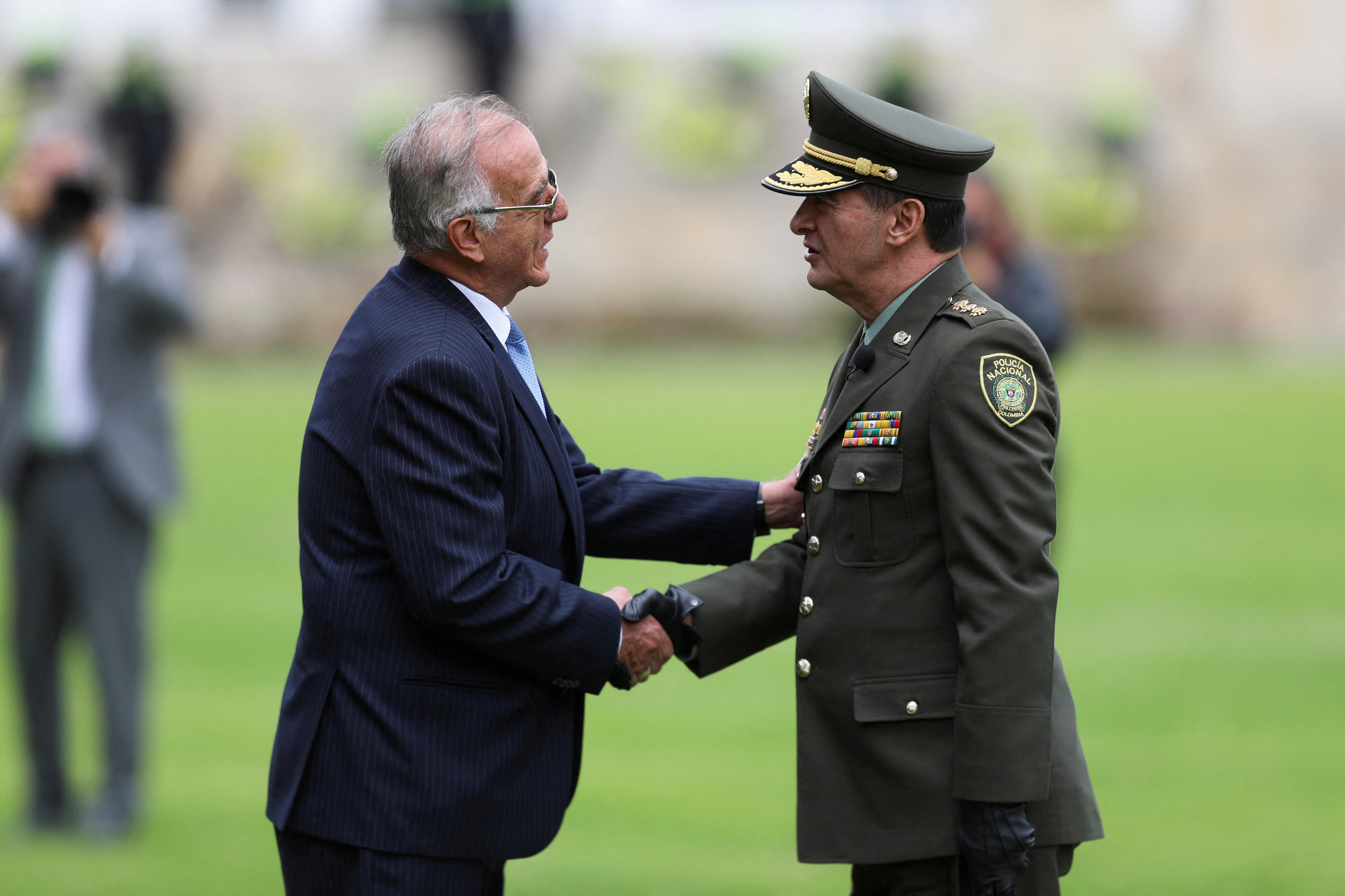 Colombia's Defense Minister Ivan Velasquez shake hands with the new Director of Police, General William Rene Salamanca, at the General Santander Police School in Bogota, Colombia May 9, 2023. REUTERS/Luisa Gonzalez