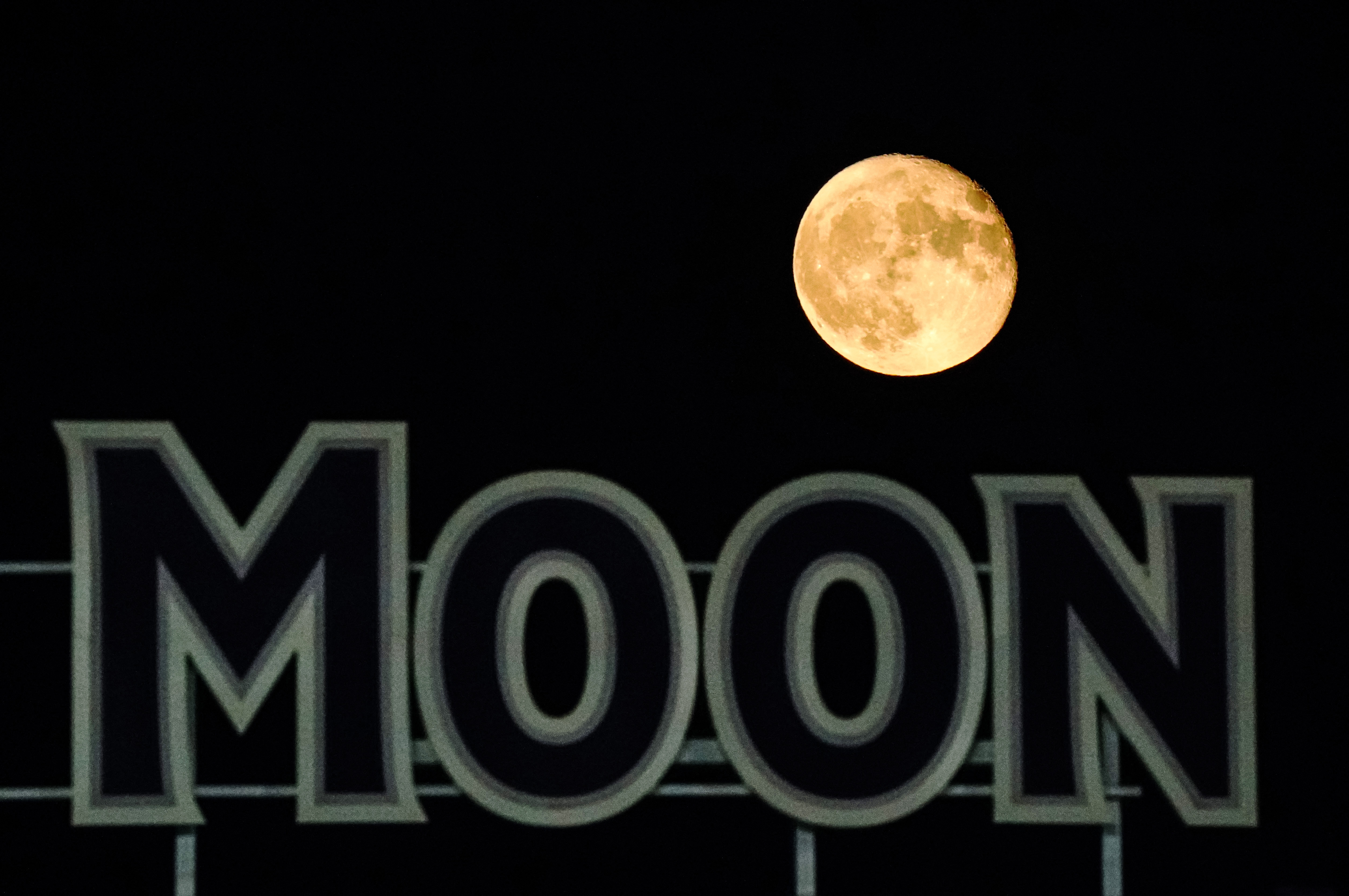 Sep 3, 2020; Kansas City, Missouri, USA; The moon is seen over a sign in right field during the seventh inning between the Chicago White Sox and the Kansas City Royals at Kauffman Stadium. Mandatory Credit: Jay Biggerstaff-USA TODAY Sports