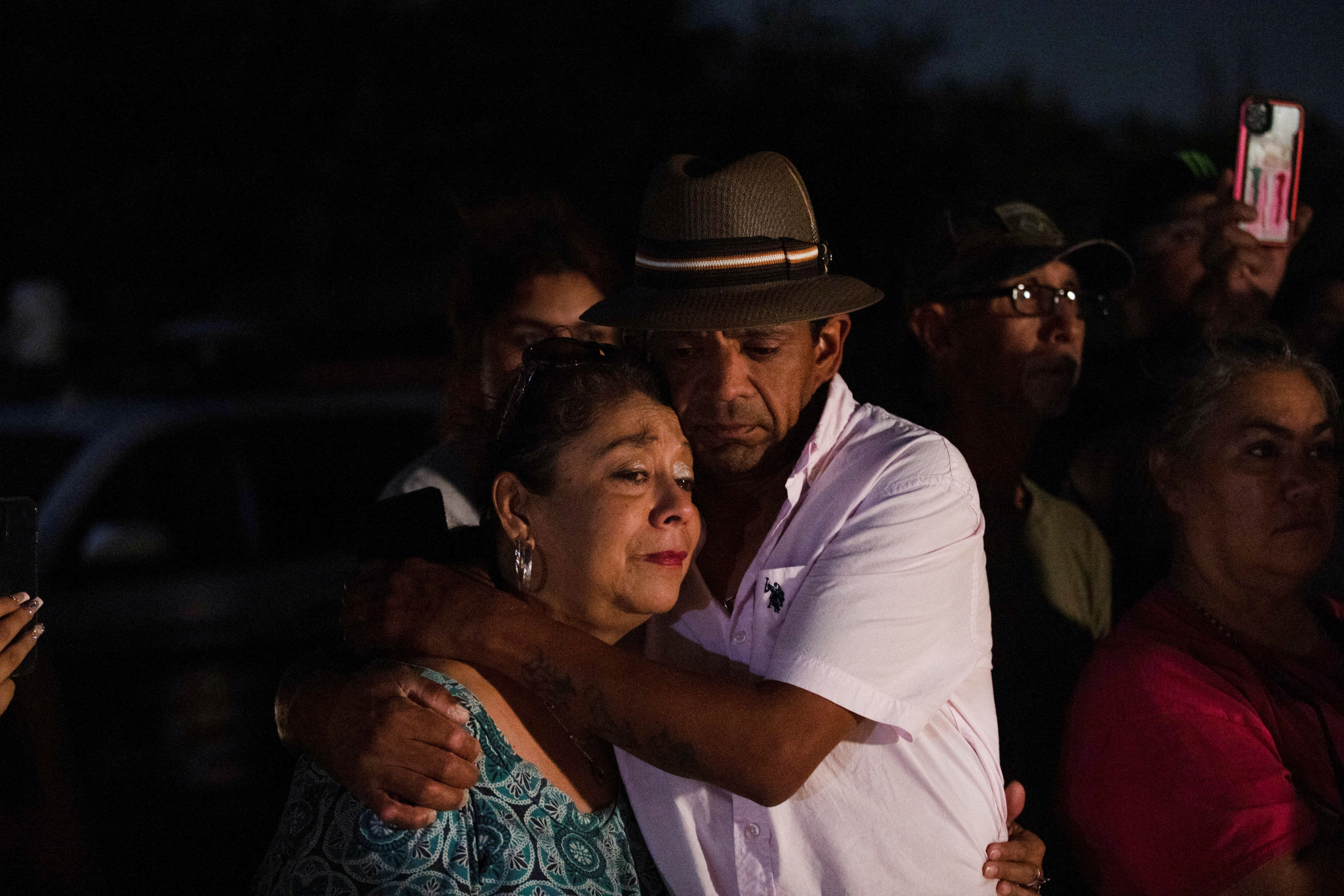 Christine and Michael Ybarra embrace at the scene where people were found dead inside a trailer truck in San Antonio, Texas, U.S. June 27, 2022. REUTERS/Kaylee Greenlee Beal     TPX IMAGES OF THE DAY