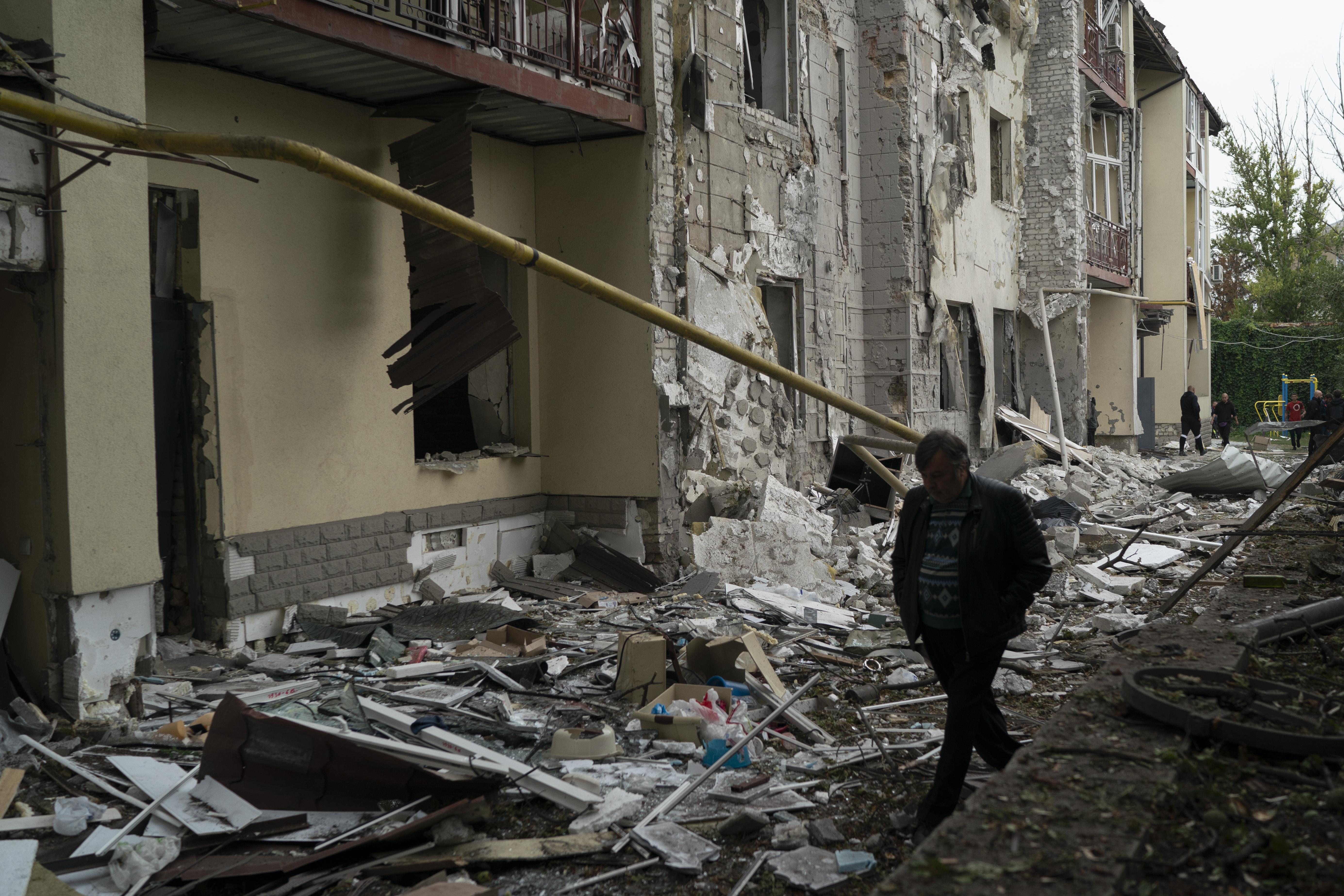 Un hombre camina sobre los escombros de un edificio residencial que resultó dañado después de un ataque ruso en Kharkiv (Foto AP/Leo Correa)