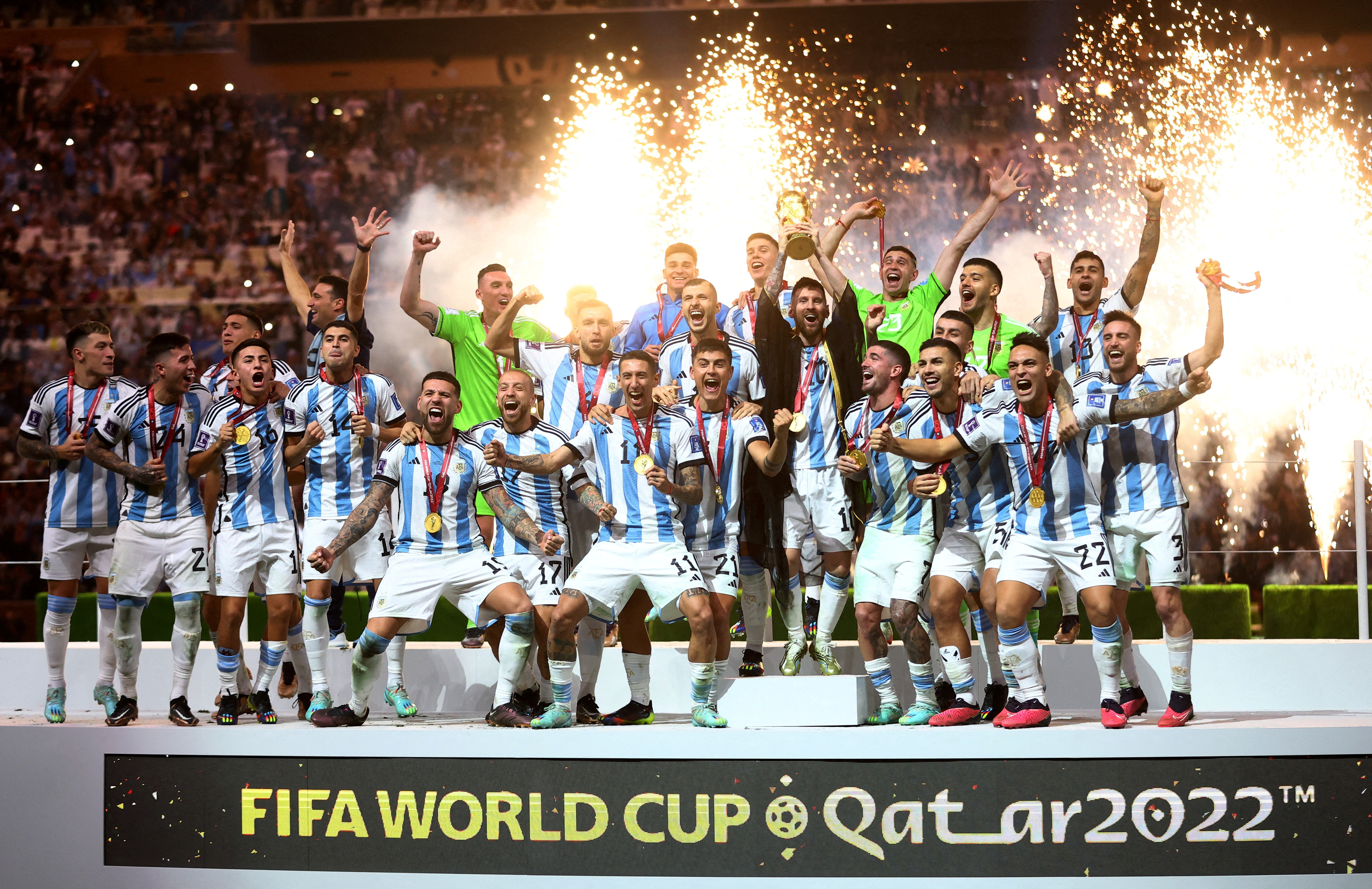 FILE PHOTO: Soccer Football - FIFA World Cup Qatar 2022 - Final - Argentina v France - Lusail Stadium, Lusail, Qatar - December 18, 2022 Argentina's Lionel Messi celebrates with the trophy and team mates after winning the World Cup REUTERS/Carl Recine/File Photo