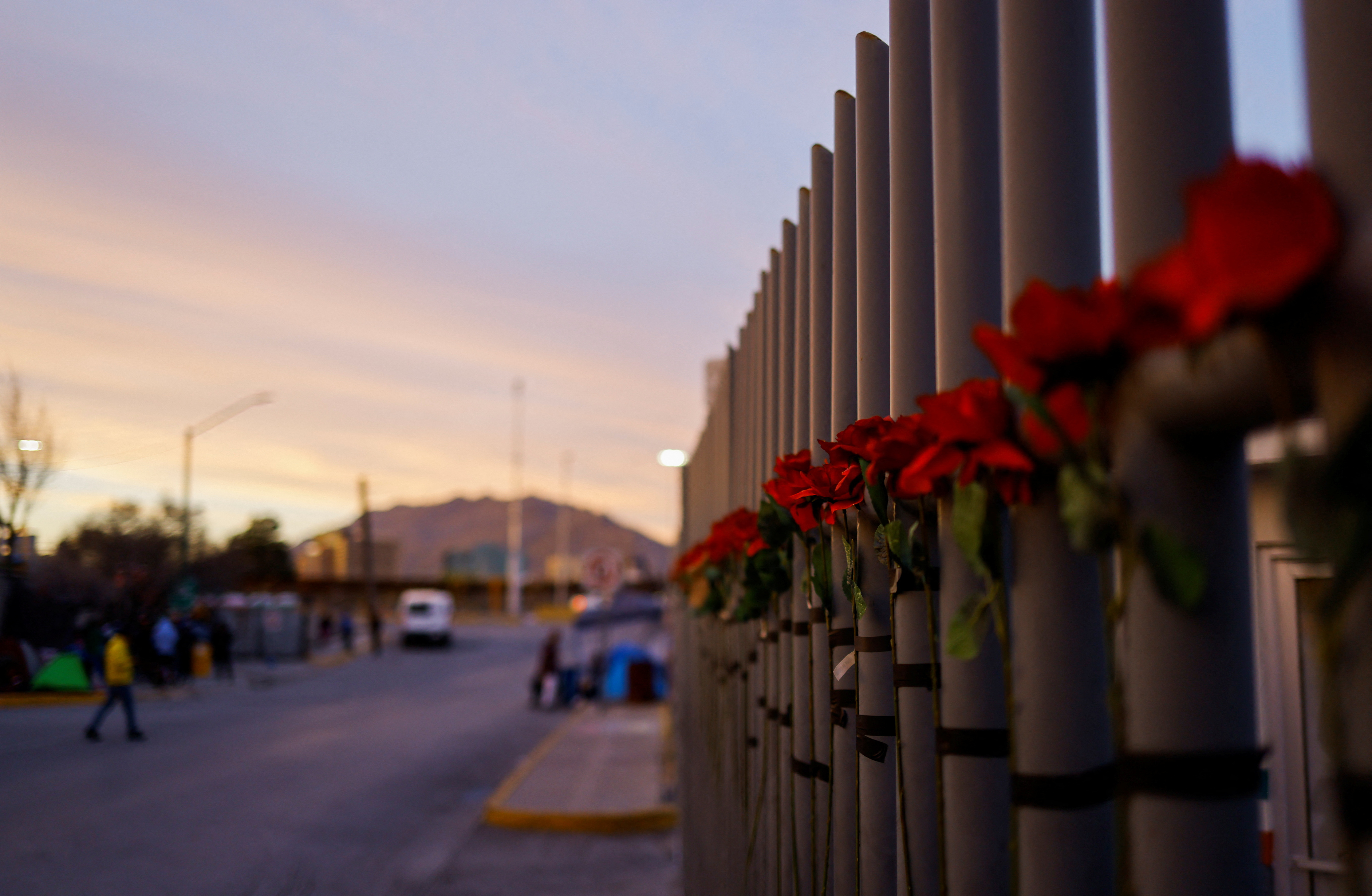 A general view of flowers on the fencing outside the immigration detention center where several migrants died after a fire broke out at the center, in Ciudad Juarez, Mexico April 5, 2023. REUTERS/Jose Luis Gonzalez