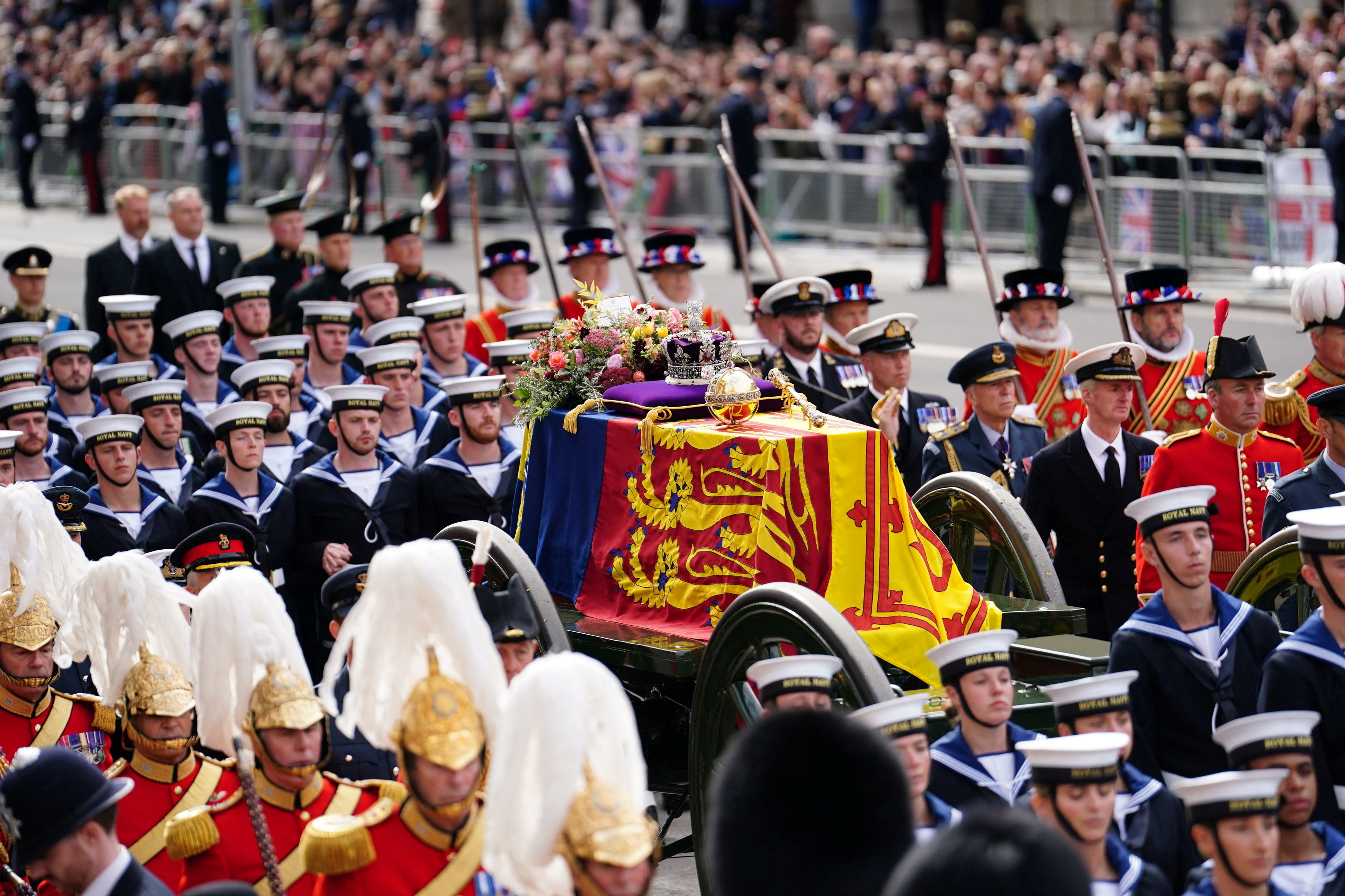The State Gun Carriage carries the coffin of Queen Elizabeth II, draped in the Royal Standard with the Imperial State Crown and the Sovereign's orb and sceptre, in the Ceremonial Procession following her State Funeral at Westminster Abbey, London. Picture date: Monday September 19, 2022. David Davies/Pool via REUTERS