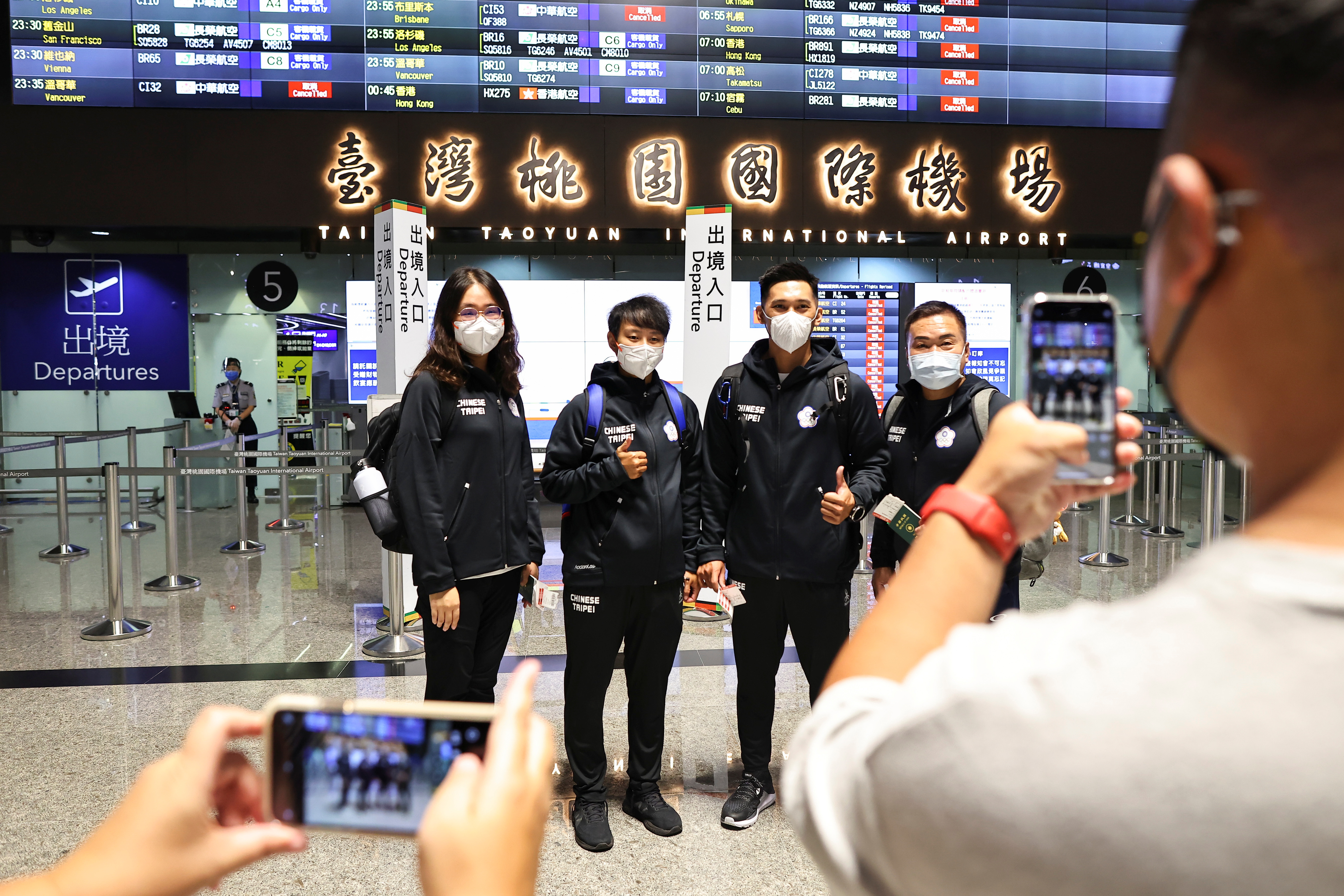 Li Sin-rong, 23, a Taiwanese luger, poses for group photos with her teammates at the airport before travelling abroad for training and competitions to qualify for the 2022 Beijing Winter Olympic Games, in Taoyuan, Taiwan October 14, 2021. Picture taken October 14, 2021. REUTERS/Ann Wang
