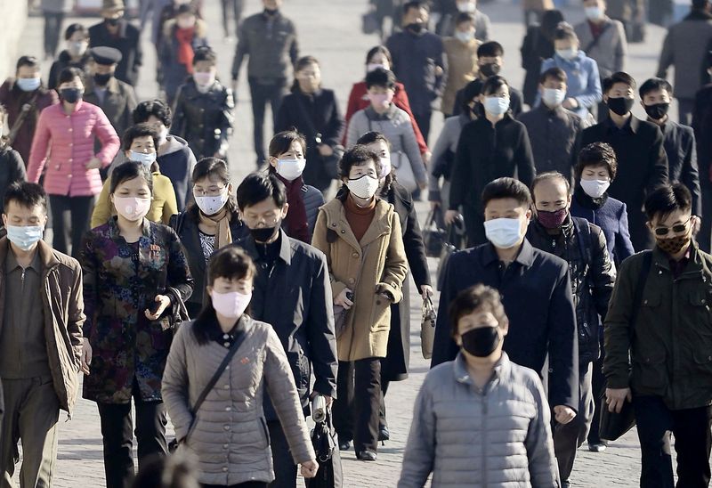 FILE PHOTO: People wearing face masks move in Pyongyang, North Korea.  March 30, 2020, in this photo posted by Kyodo.  Mandatory Credit Kyodo/via REUTERS