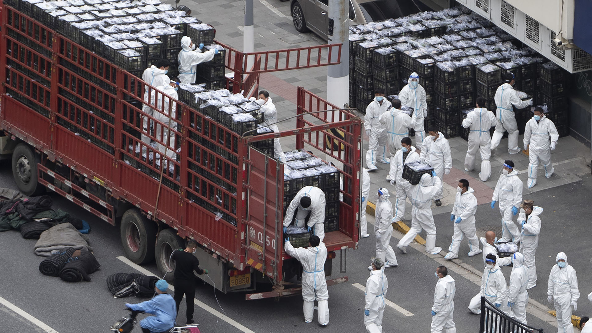 Chinese workers unload food on April 5, 2022 in Shanghai, China.