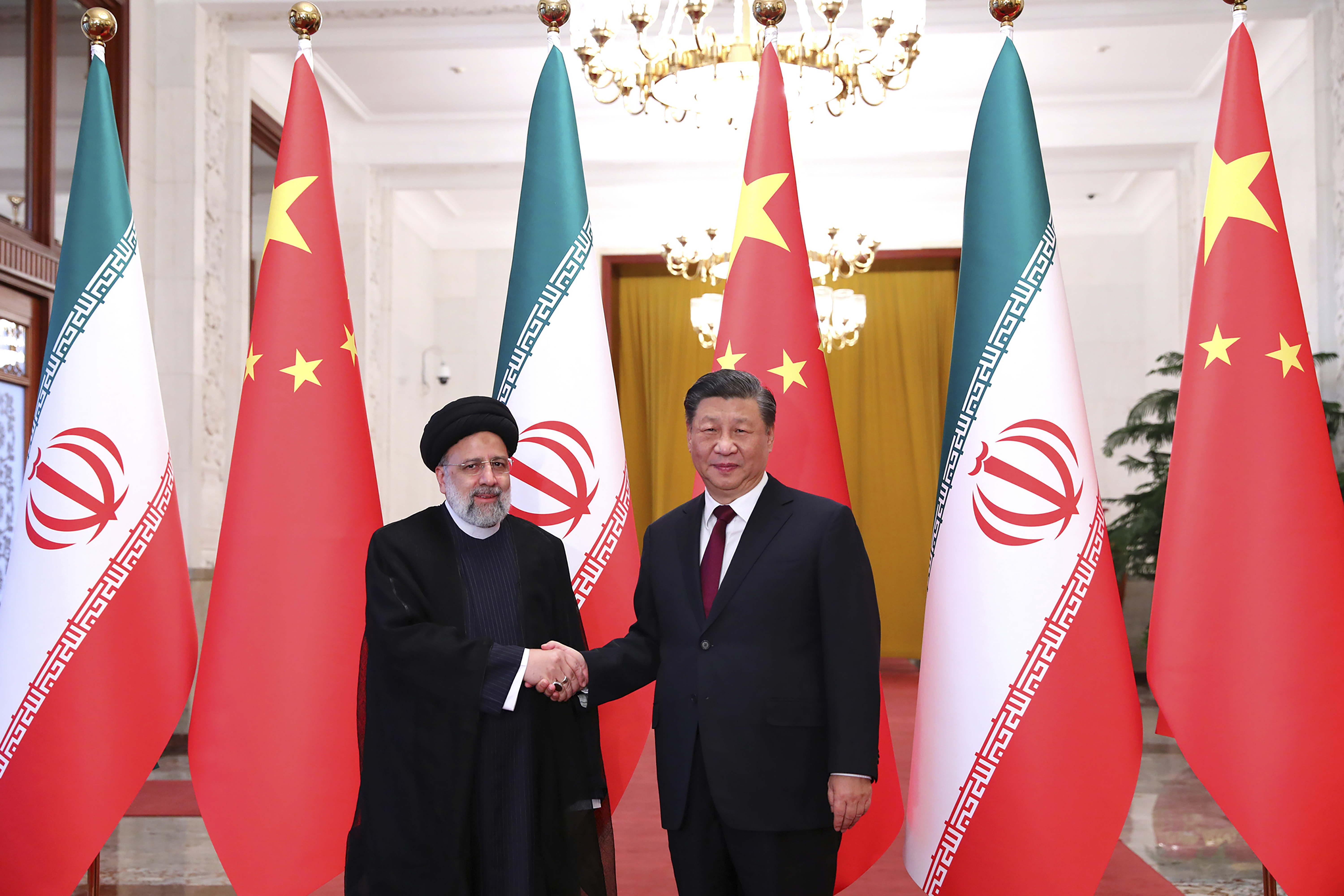 FILE - In this photo released by the official website of the Iranian presidential office, President Ebrahim Raisi, left, greets his Chinese counterpart Xi Jinping at an official welcoming ceremony in Beijing, Tuesday, February 14, 2023. (Iranian presidential office via AP, file)