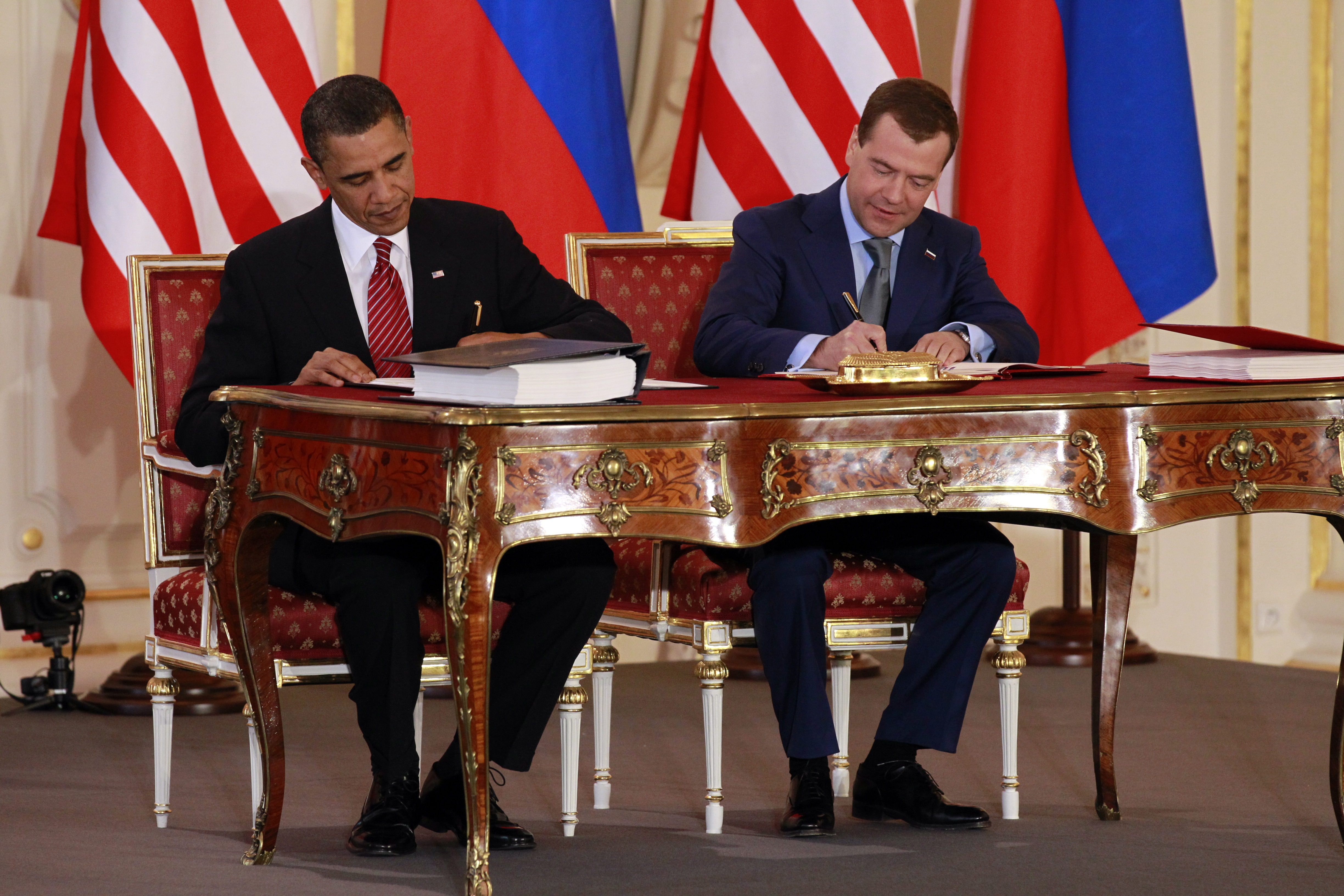 Former Presidents Barack Obama of the United States, left, and Dmitry Medvedev of Russia sign the New START nuclear treaty April 8, 2010 at Prague Castle.  AP Photo/Alex Brandon/File
