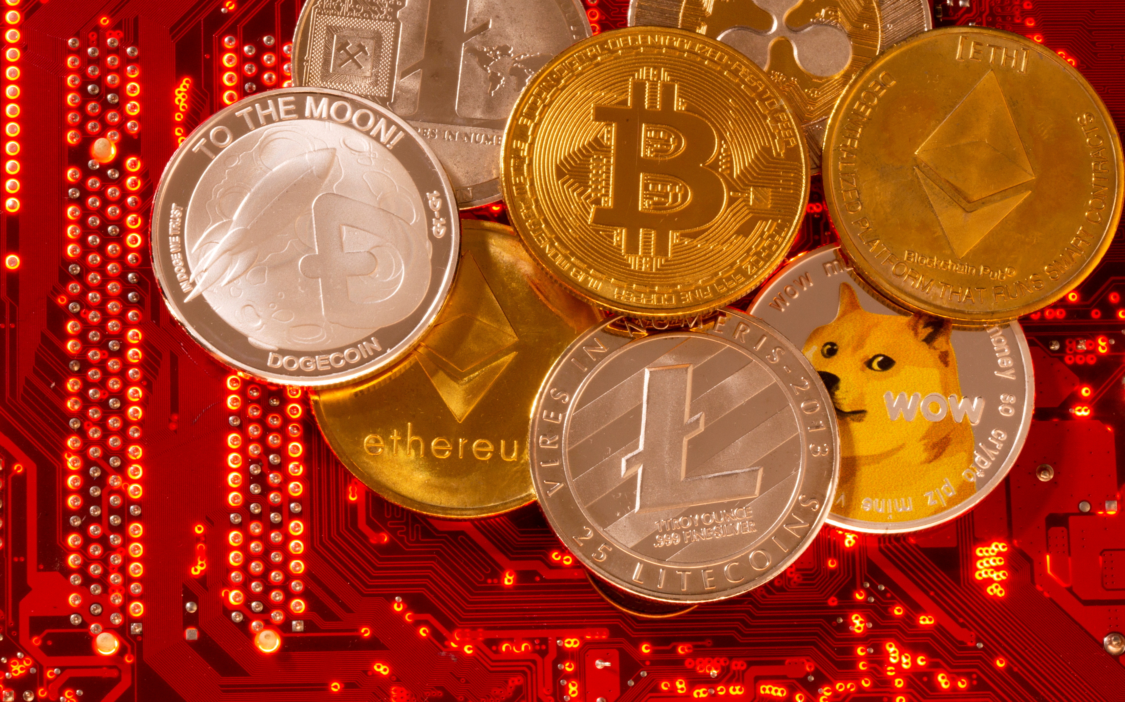 FILE PHOTO: FILE PHOTO: Representations of cryptocurrencies Bitcoin, Ethereum, DogeCoin, Ripple, Litecoin are placed on PC motherboard in this illustration taken, June 29, 2021. REUTERS/Dado Ruvic/Illustration//File Photo/File Photo