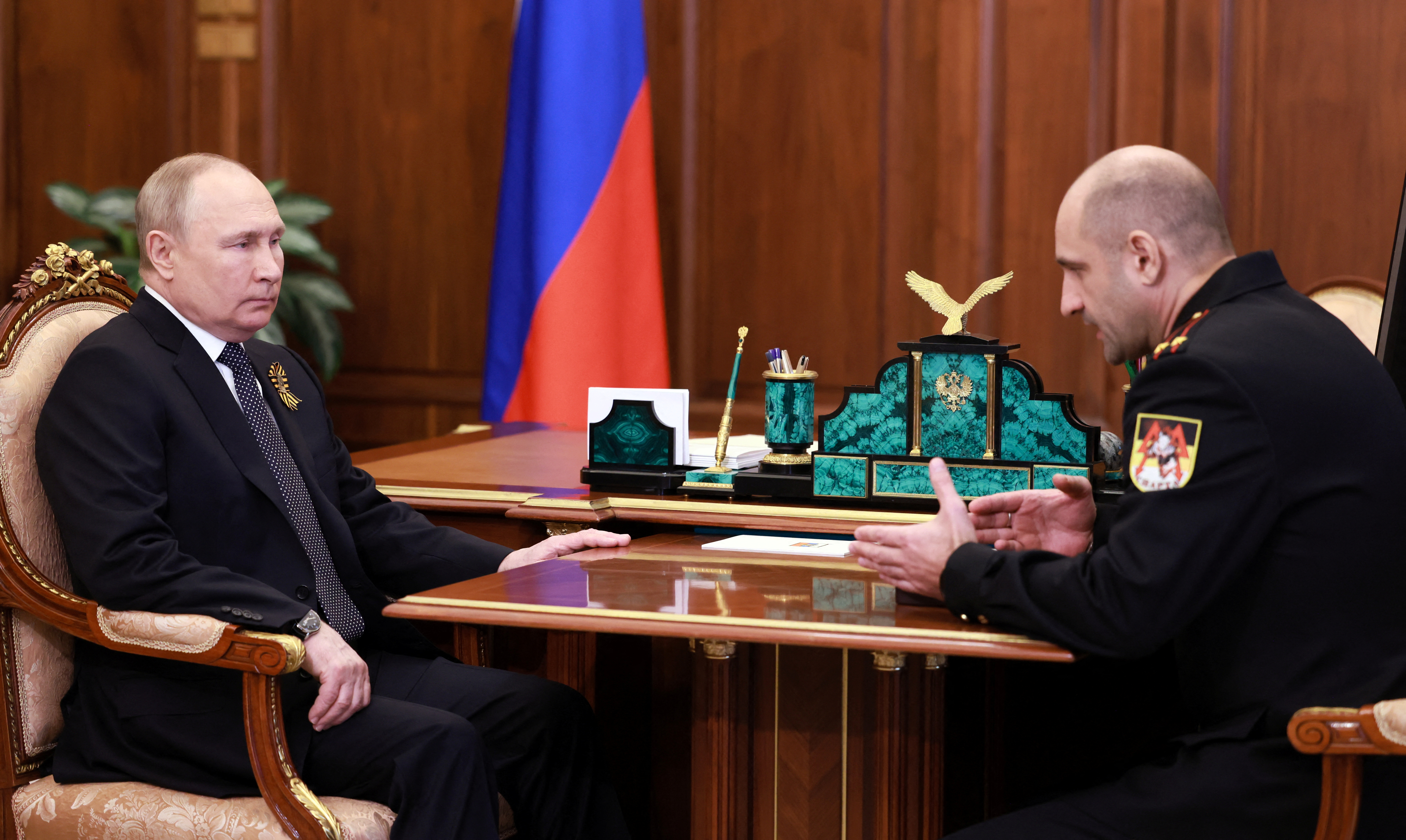 Russian President Vladimir Putin attends a meeting with Artyom Zhoga, father of commander of the Sparta Battalion pro-Russian military unit Vladimir Zhoga who was killed in a conflict in Ukraine, following the parade on Victory Day, which marks the 77th anniversary of the victory over Nazi Germany in World War Two, in Moscow, Russia May 9, 2022. Sputnik/Mikhail Metzel/Pool via REUTERS ATTENTION EDITORS - THIS IMAGE WAS PROVIDED BY A THIRD PARTY.