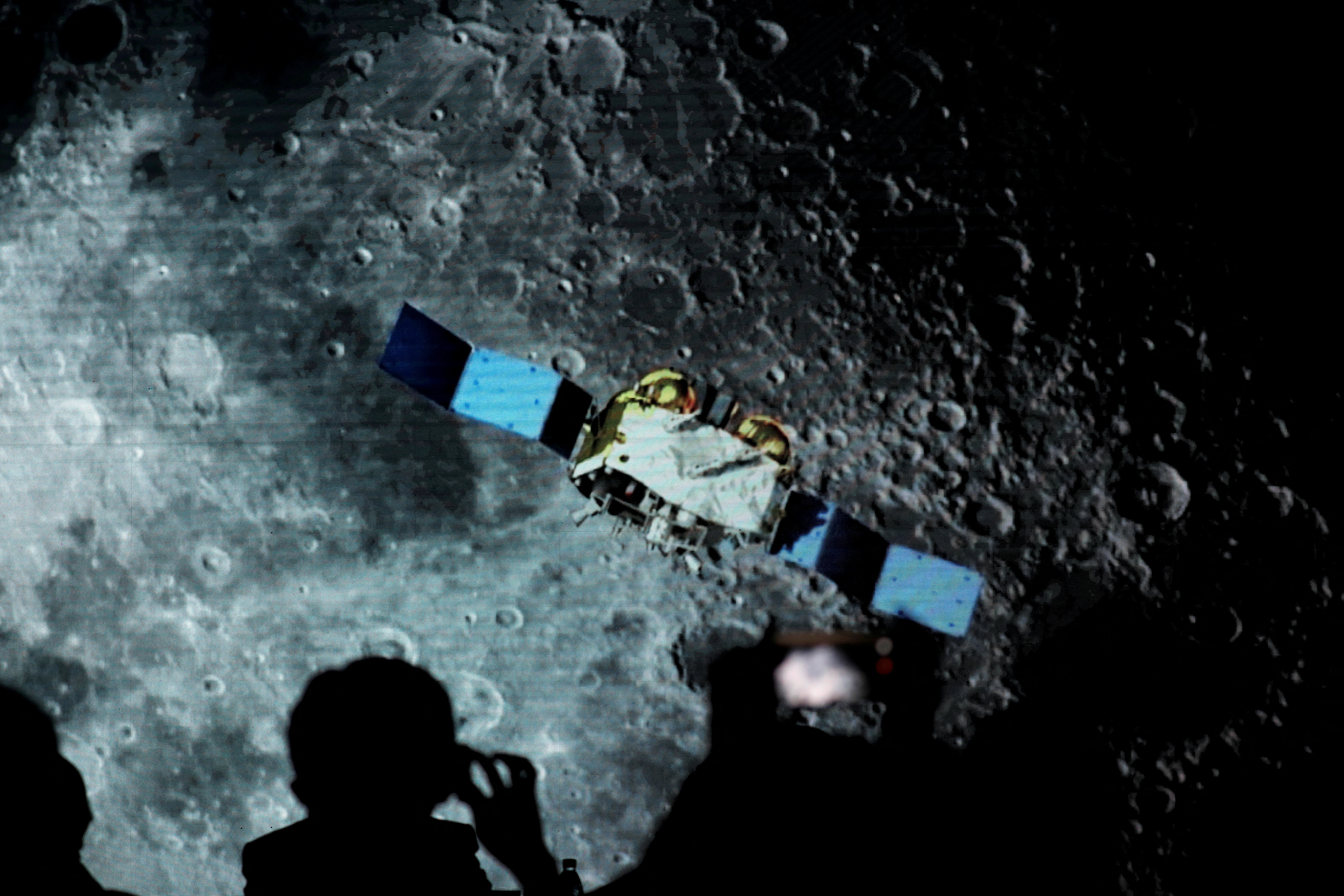 FILE PHOTO: Screen shows footages of spacecraft for Chang'e-5 Mission, during an event on China’s lunar exploration program, at the National Astronomical Observatories of Chinese Academy of Sciences, in Beijing