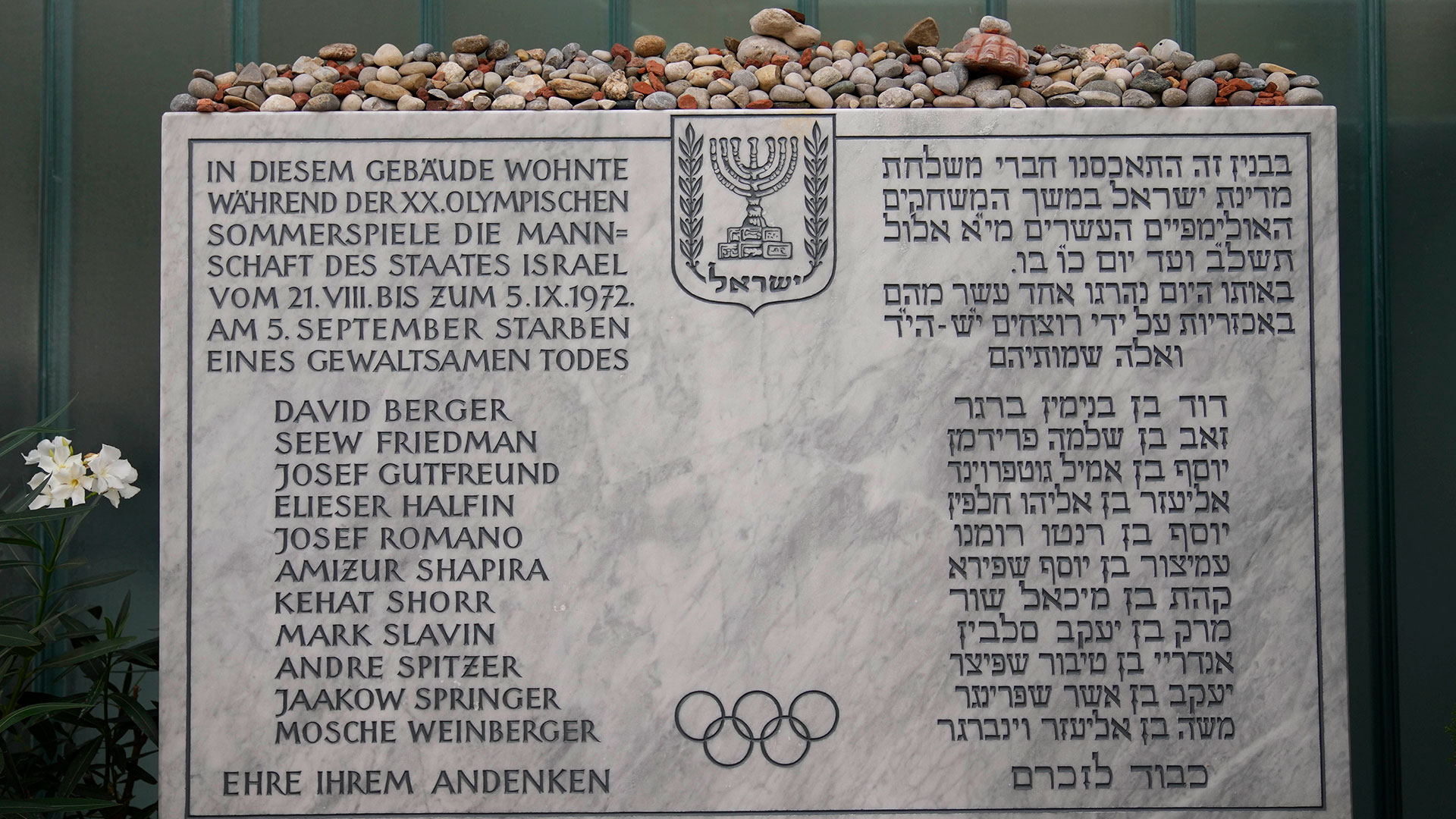 A plaque commemorates eleven Israeli athletes and a German police officer who were killed in a terrorist attack during the 1972 Olympics at the former Israeli team hotel in the Olympic Village in Munich, Germany, Saturday, August 27, 2019.  The families of 11 Israeli athletes killed by Palestinian attackers at the 1972 Summer Olympics and the German government are close to reaching an agreement on long-disputed compensation.  (AP Photo/Matthias Schrader)