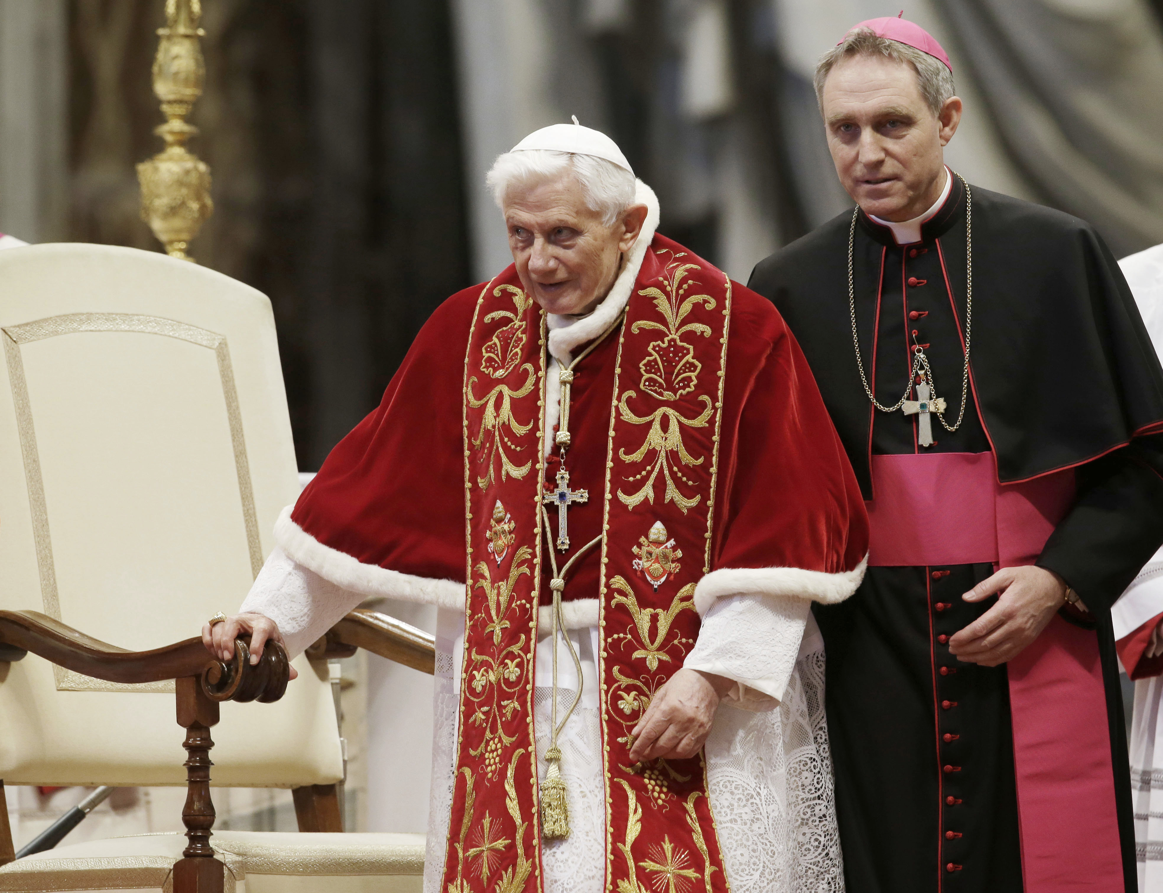 FILE - Pope Benedict XVI, accompanied by his personal secretary, Archbishop Georg Gaenswein, during the celebration of a mass for the 900th anniversary of the Knights of the Order of Malta, in Saint Peter's Basilica, in the Vatican, on 9 February 2013. (AP Photo/Gregorio Borgia, File)