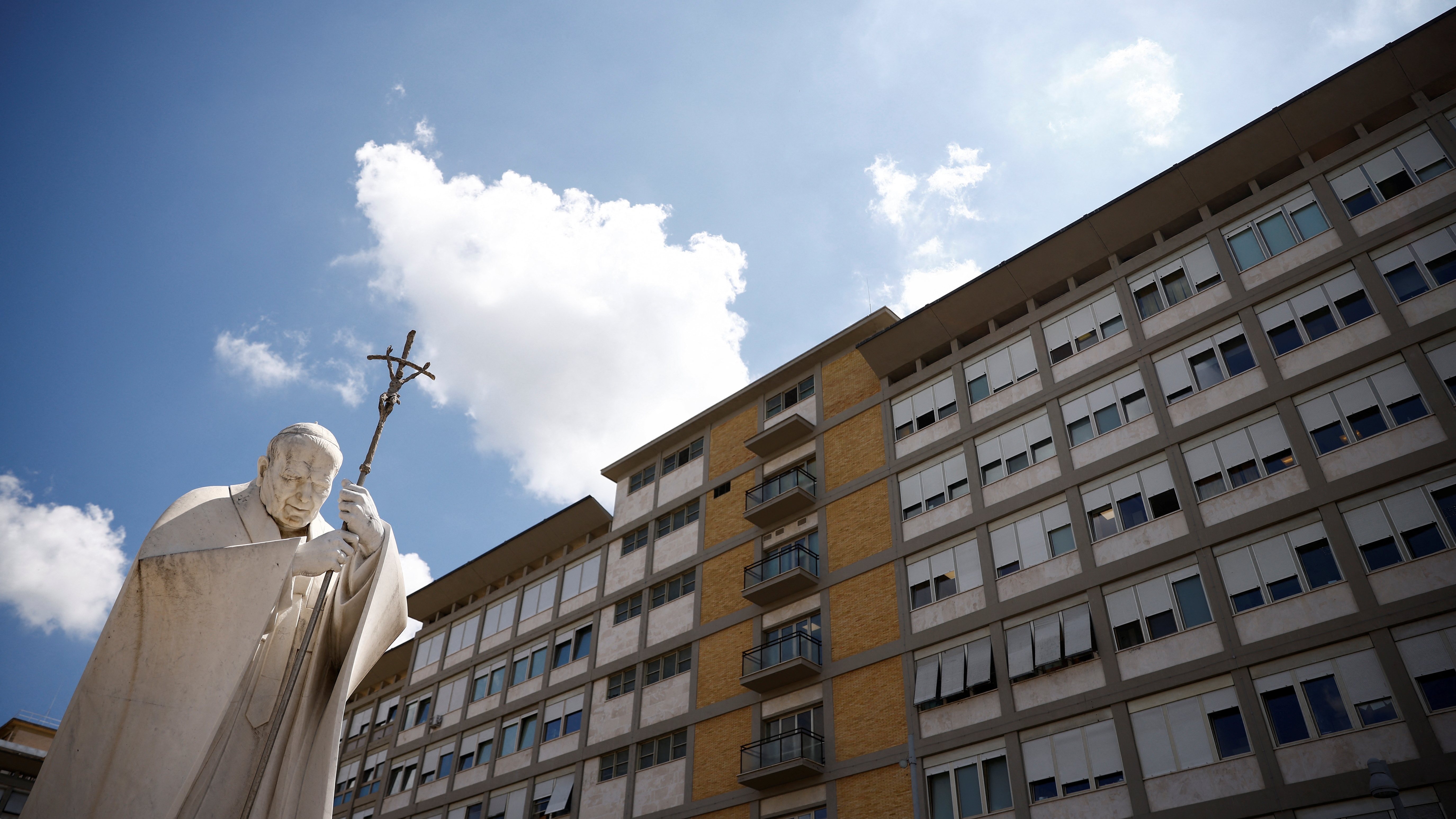A view of a statue of Pope John Paul II outside the Gemelli Hospital where Pope Francis is due to undergo the abdominal surgery, in Rome, Italy, June 7, 2023. REUTERS/Guglielmo Mangiapane