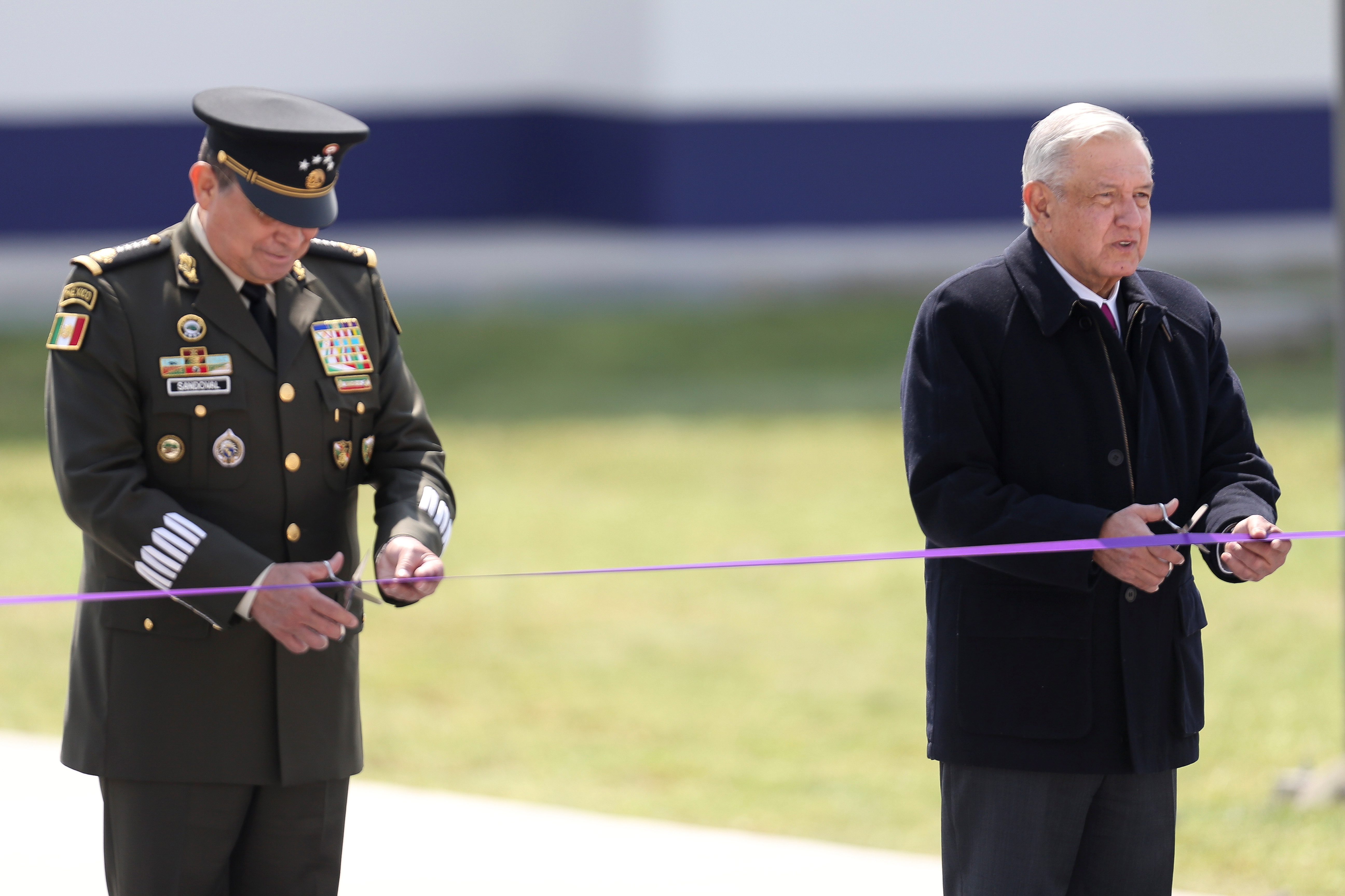 Mexican President Andres Manuel Lopez Obrador and Secretary of Defense Luis Sandoval cut a ribbon during the inauguration of the first stage of the new international airport in Zumpango de Ocampo, at the Santa Lucia military airbase on the outskirts of Mexico City, Mexico February 10, 2021. REUTERS/Edgard Garrido