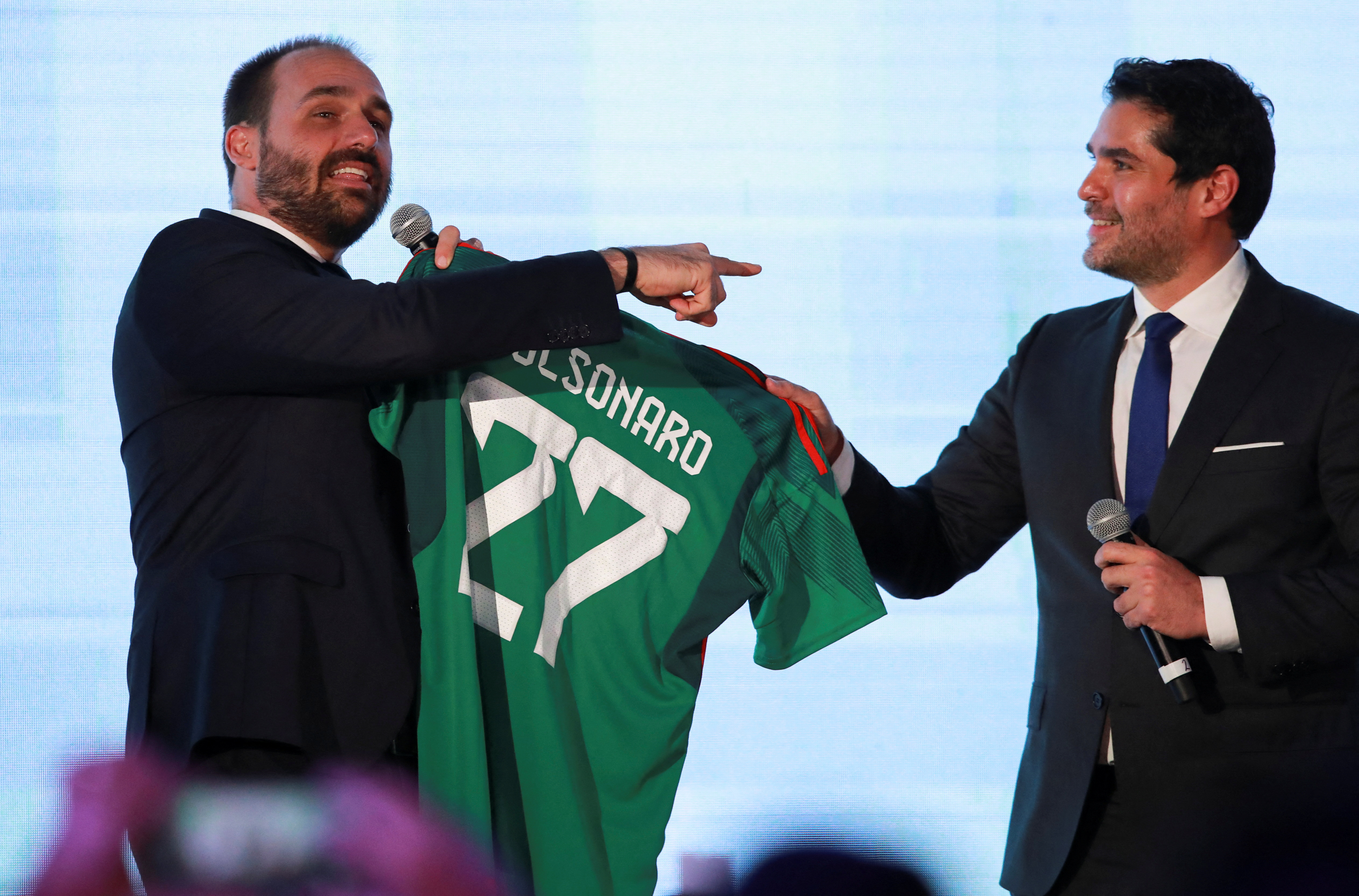Brazilian politician and lawyer Eduardo Bolsonaro receives a football jersey of the Mexican national team with his name on it from CPAC Mexico's Eduardo Verastegui, after his speech during the Conservative Political Action Conference (CPAC) in Mexico City, Mexico November 18, 2022. REUTERS/ henry romero