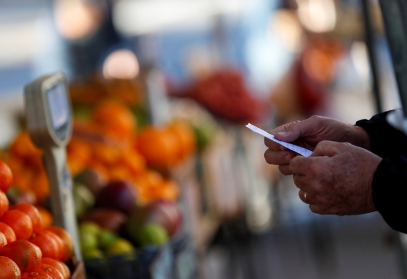 Foto de archivo. Un cliente sostiene su lista de compras frente a un puesto en un mercado callejero, en Buenos Aires, Argentina. Jun 15, 2021. REUTERS/Agustin Marcarian