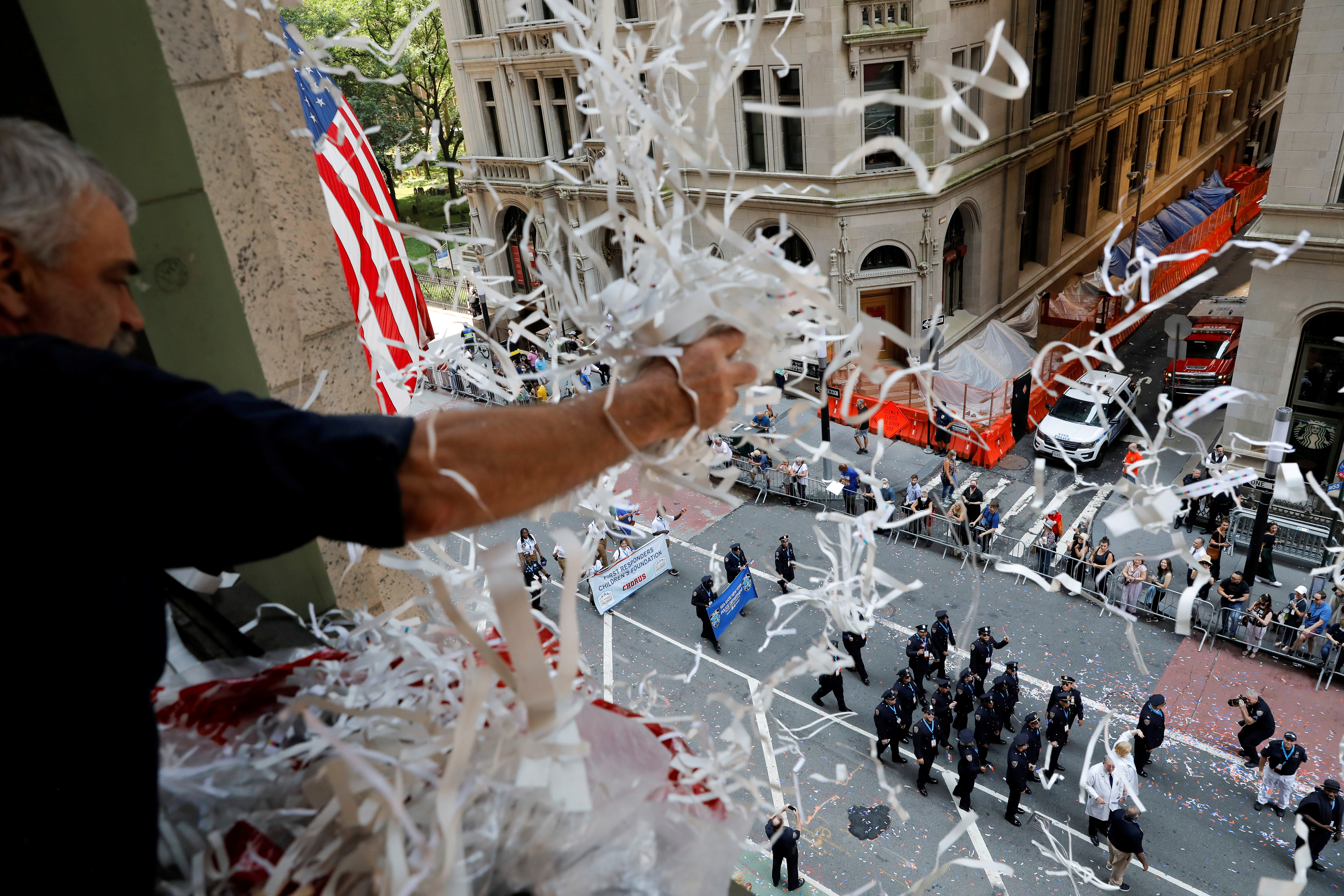 People take part in the Hometown Heroes ticker tape parade, to honor essential workers for their work during the outbreak of the coronavirus disease (COVID-19), up New York City's "Canyon of Heroes" in lower Manhattan in New York City, New York, U.S., July 7, 2021. REUTERS/Andrew Kelly     TPX IMAGES OF THE DAY