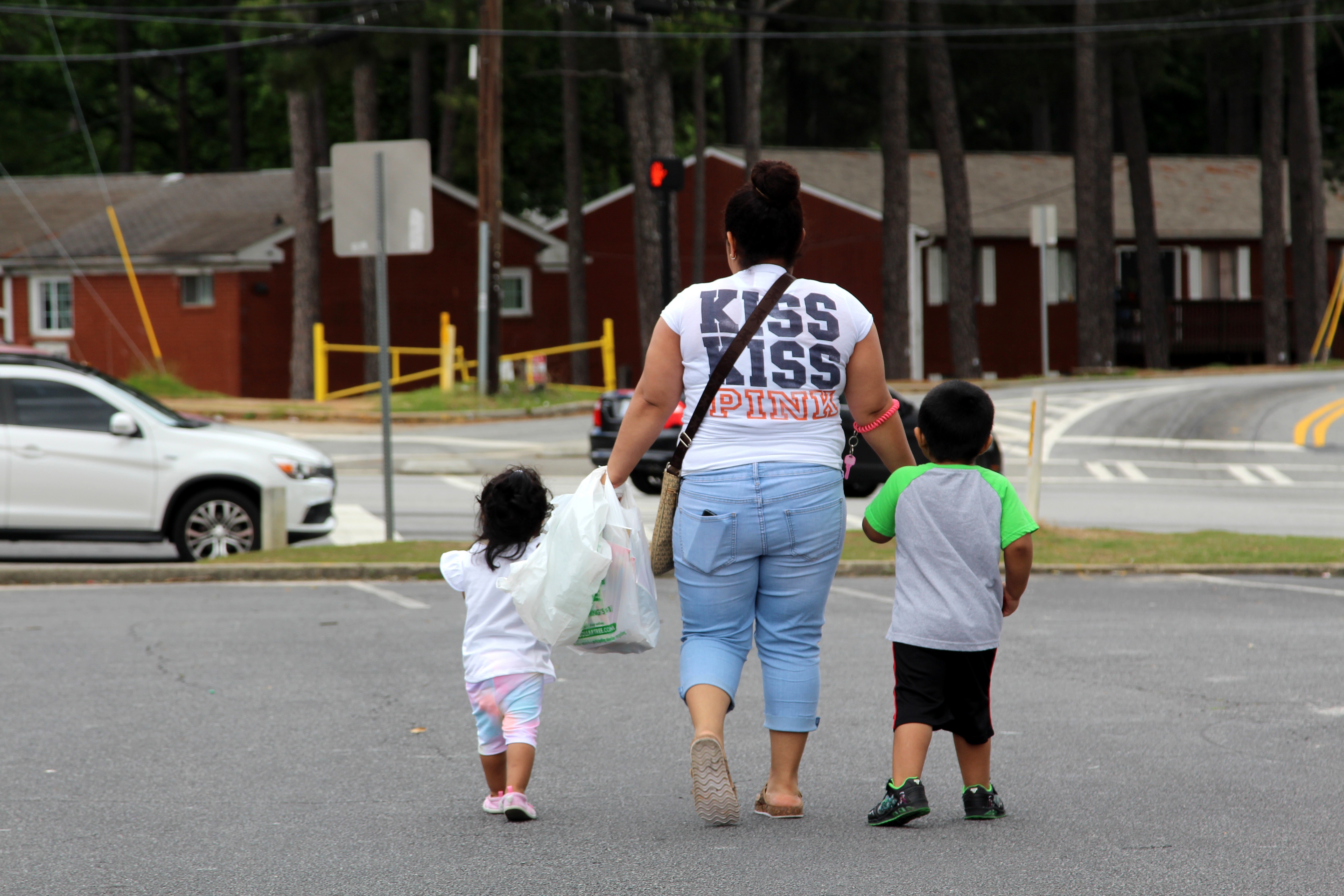 Una mujer camina con dos niños de la mano en EEUU (Foto: EFE)

