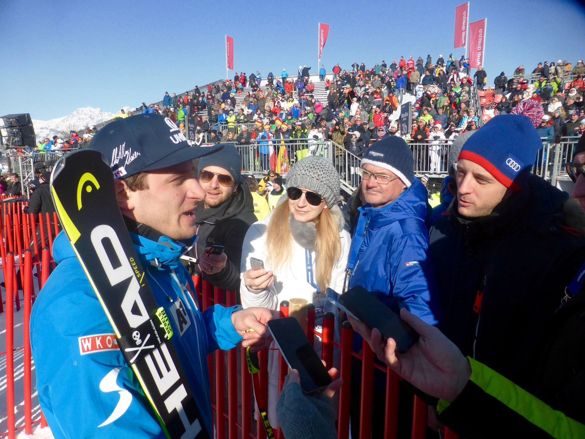 Austrian Olympic and Hahnenkamm champion Matthias Mayer does interviews in the Kitzbuhel finish area (Pinelli)